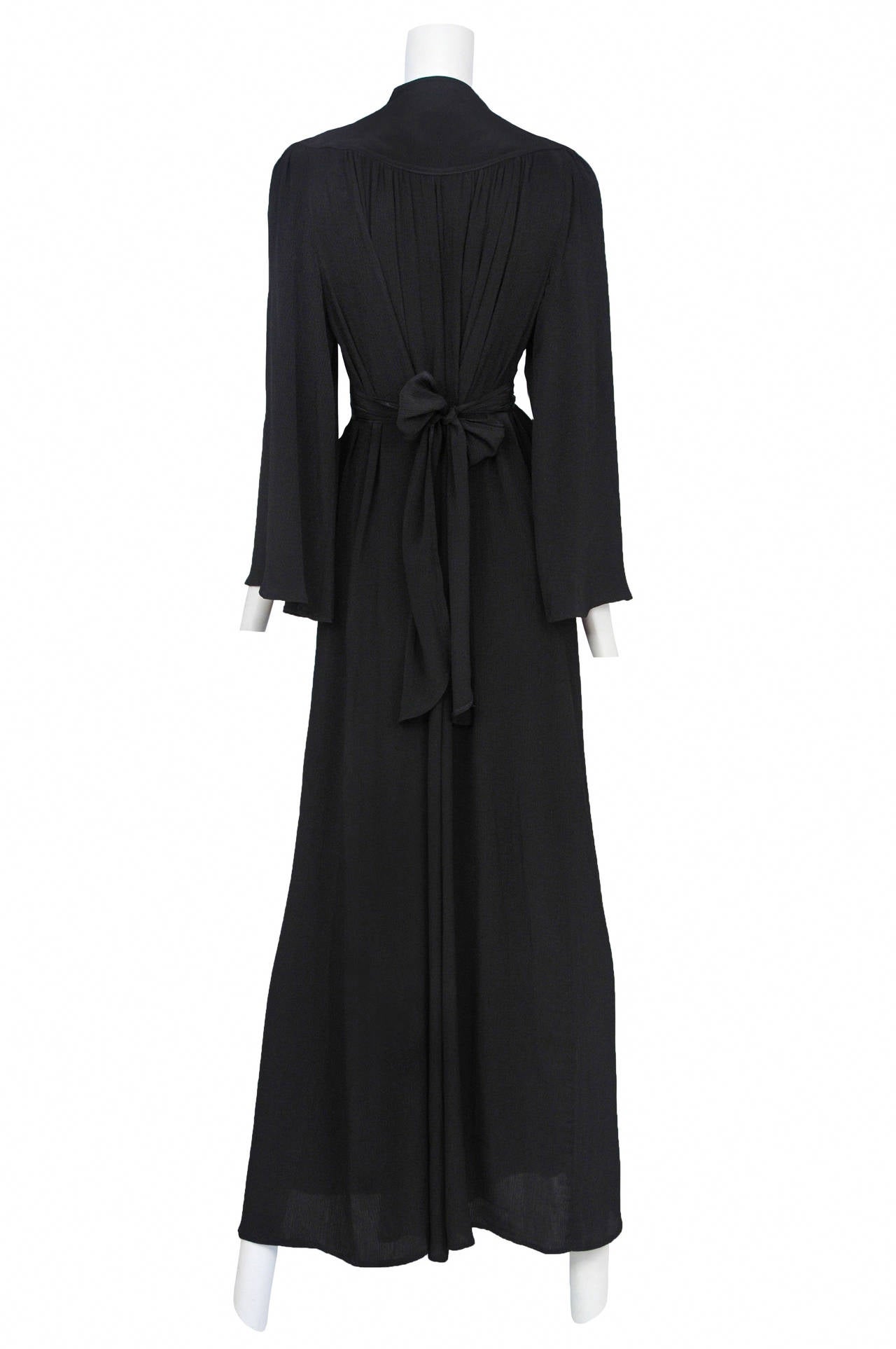 Vintage Ossie Clark black crepe Graduation Gown featuring long sleeves and built in tie at the waist. 

Measurements: Free in size. Bust and waist are 50