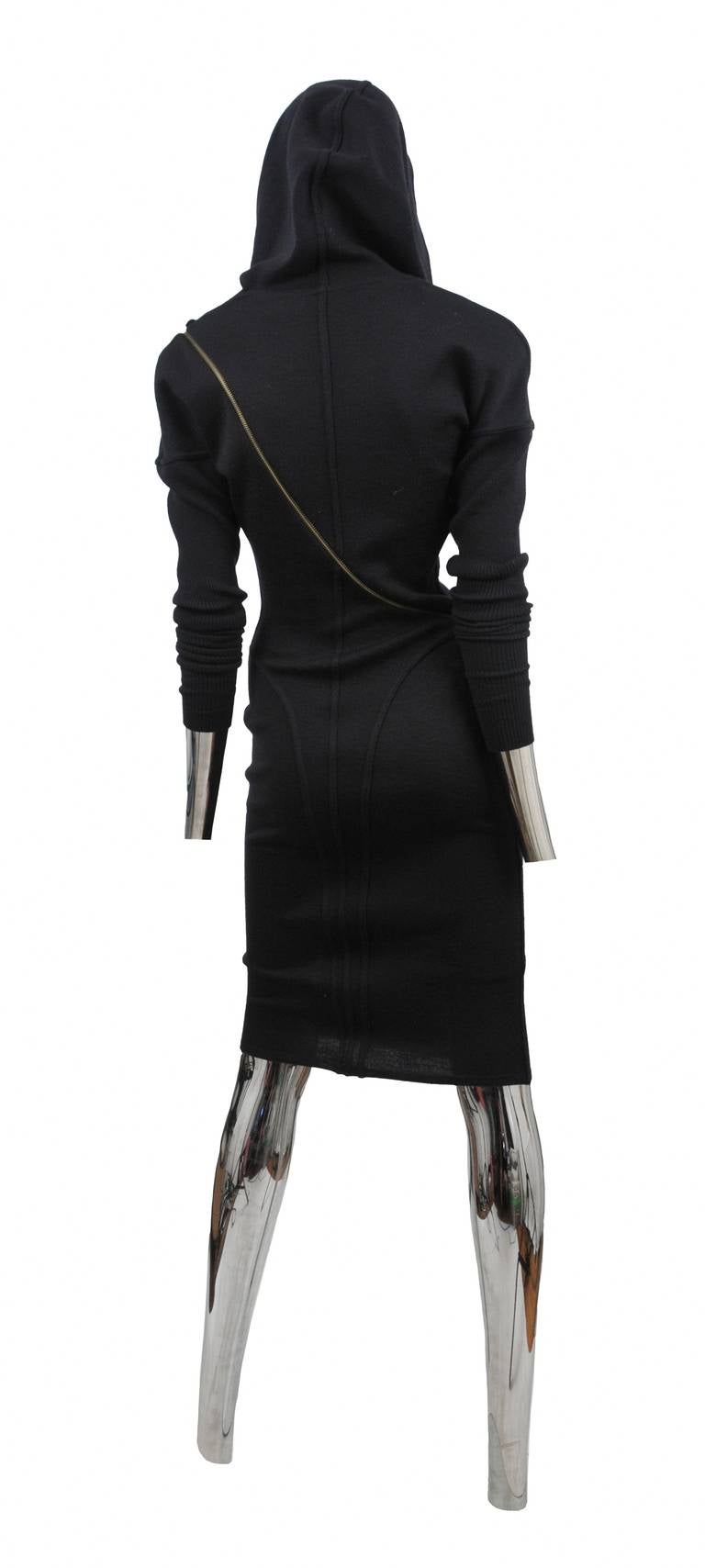 Black wool iconic zipper dress with hood and brass zipper detail that wraps around the body.