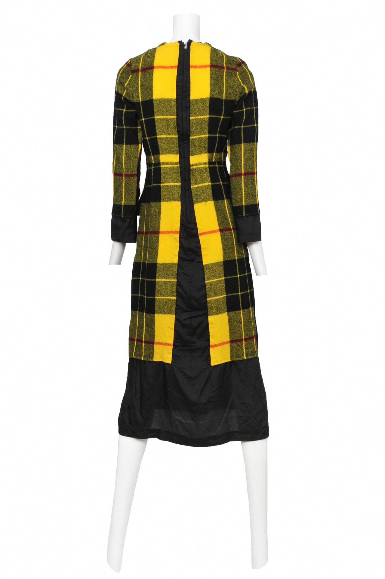 Vintage Comme des Garcons long sleeve yellow and black plaid boiled wool dress featuring black contrast fabric at the cuffs and hem.