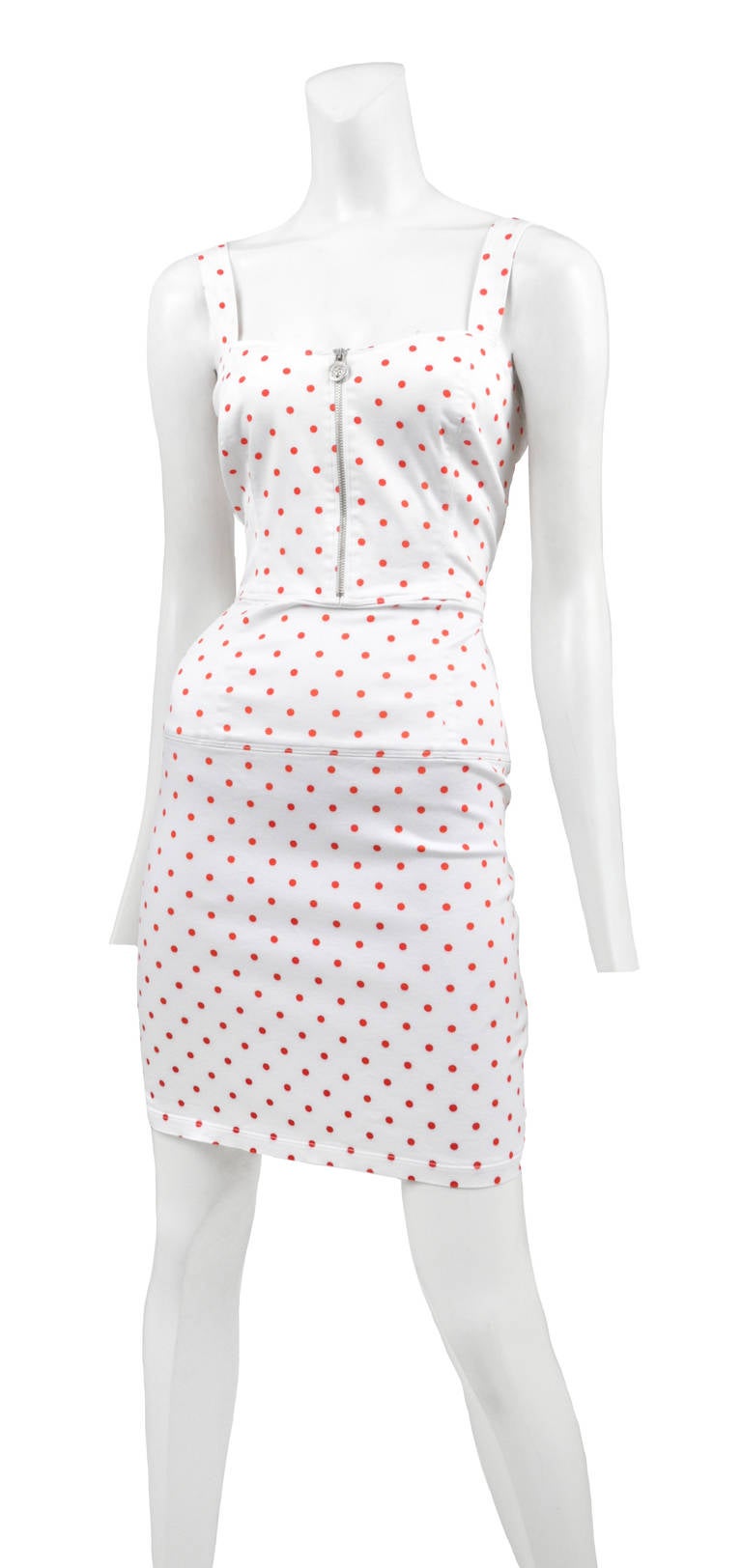 White stretch cotton sun dress with tiny red polka print. Front silver zip closure with medusa head zipper pull.