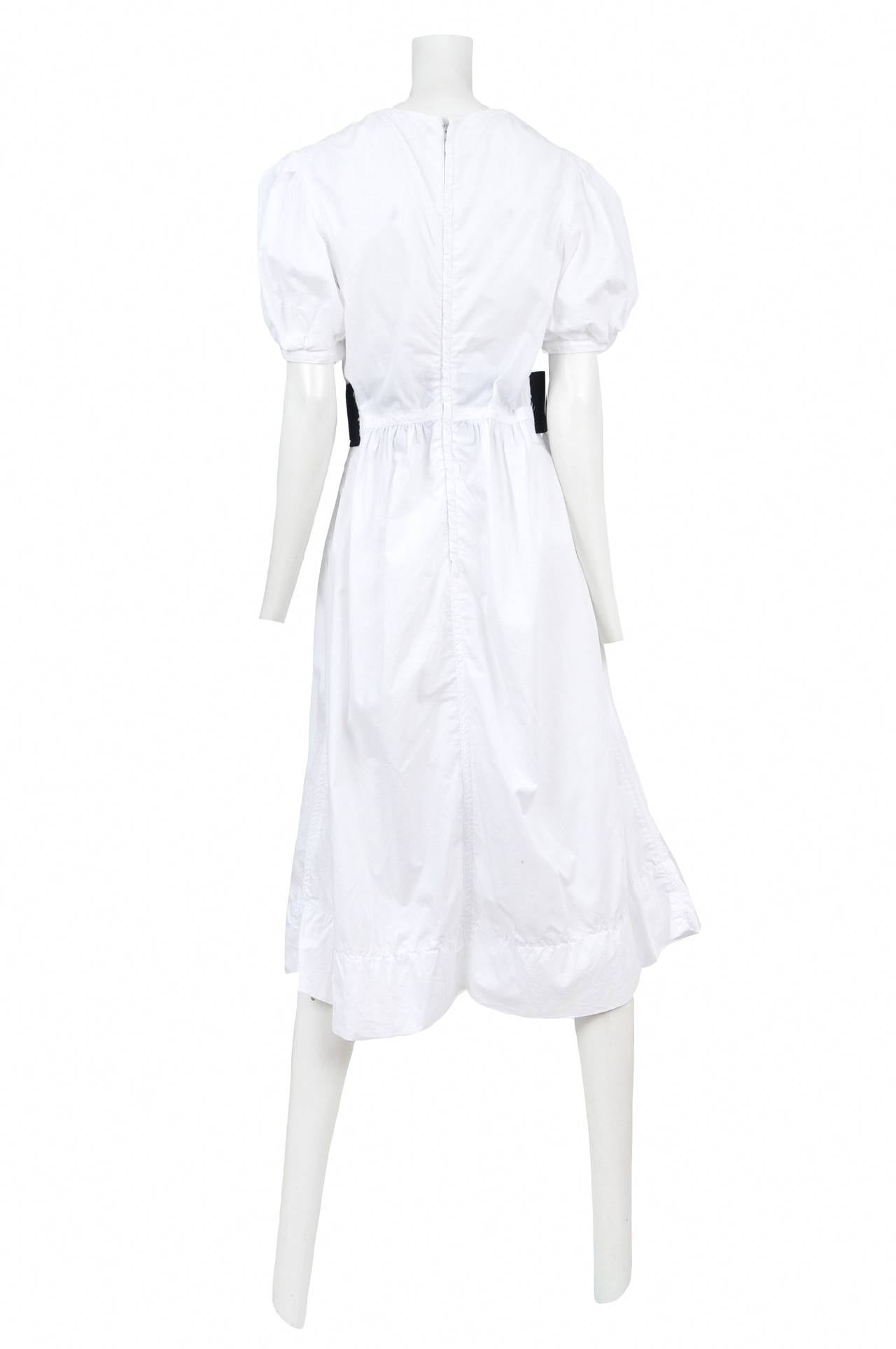 Vintage Comme des Garcons white short sleeve peasant mid-length dress featuring a wide black elastic waistband. Circa Spring 2010.