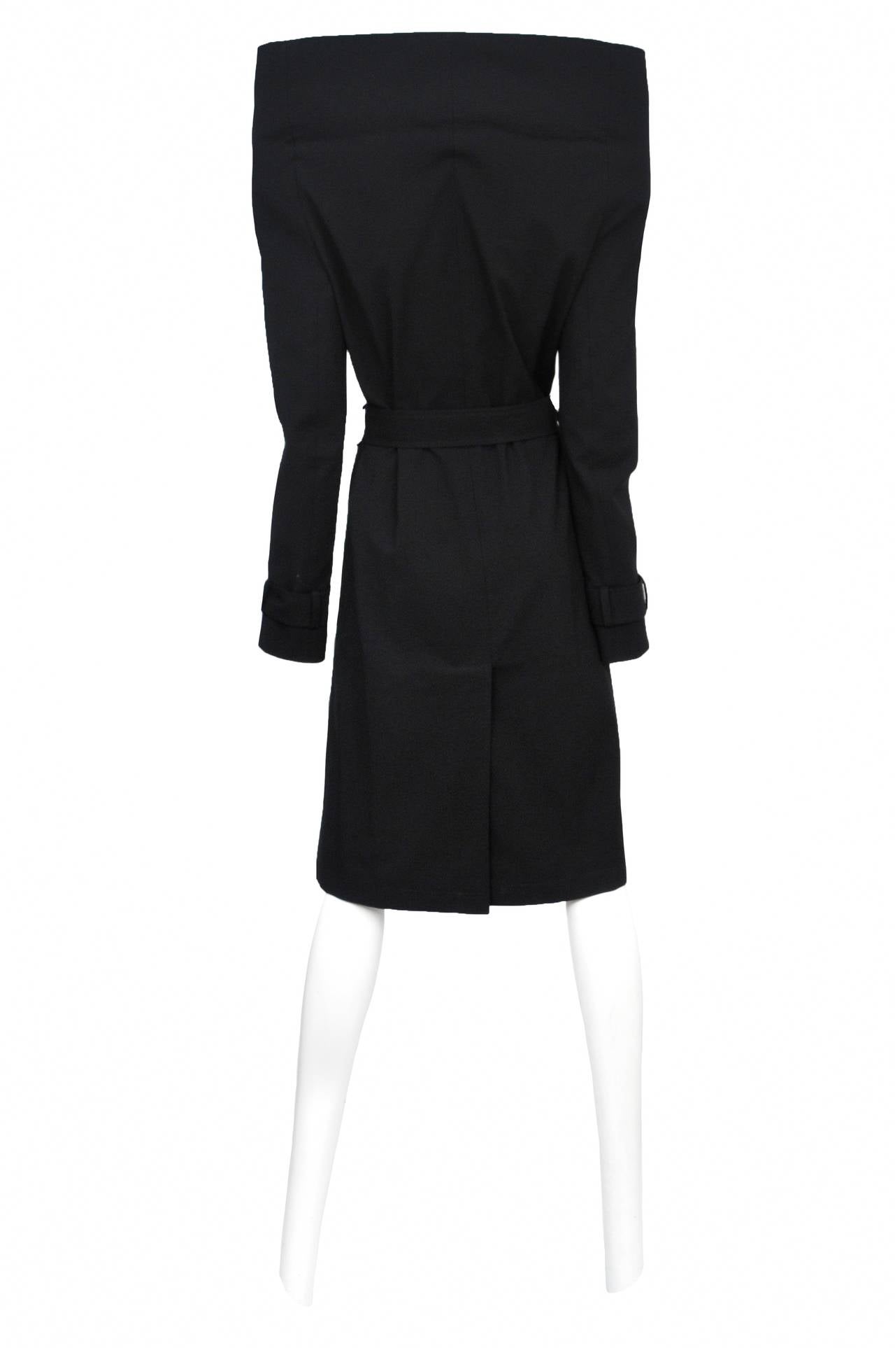 Vintage Margiela iconic black trench coat featuring accentuated shoulder and stand alone collar as well as matching waist belt. Runway piece from the Fall/Winter 2008 Collection.