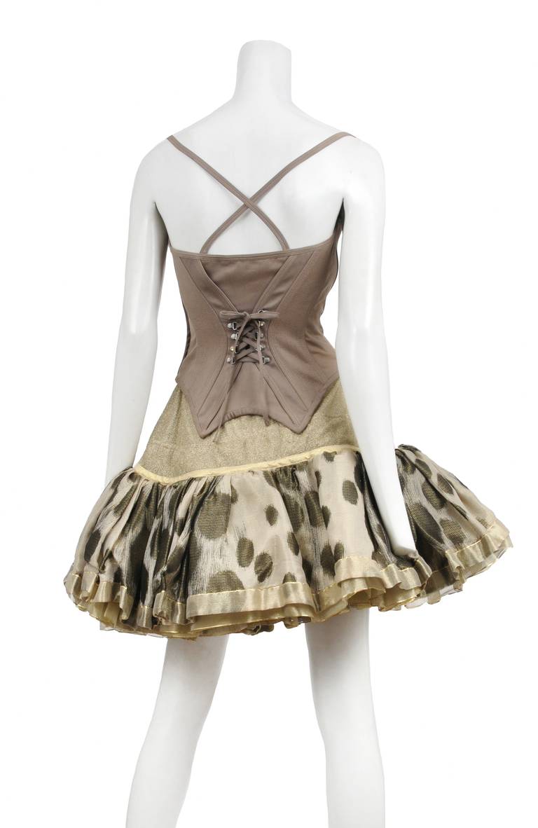 Rare vintage Atelier Versace cocktail ensemble. Gold metallic multi layered petticoat skirt with spot print on top layer. Khaki bustier top with corset tie detail at front and crisscross back straps. Circa 1990's.