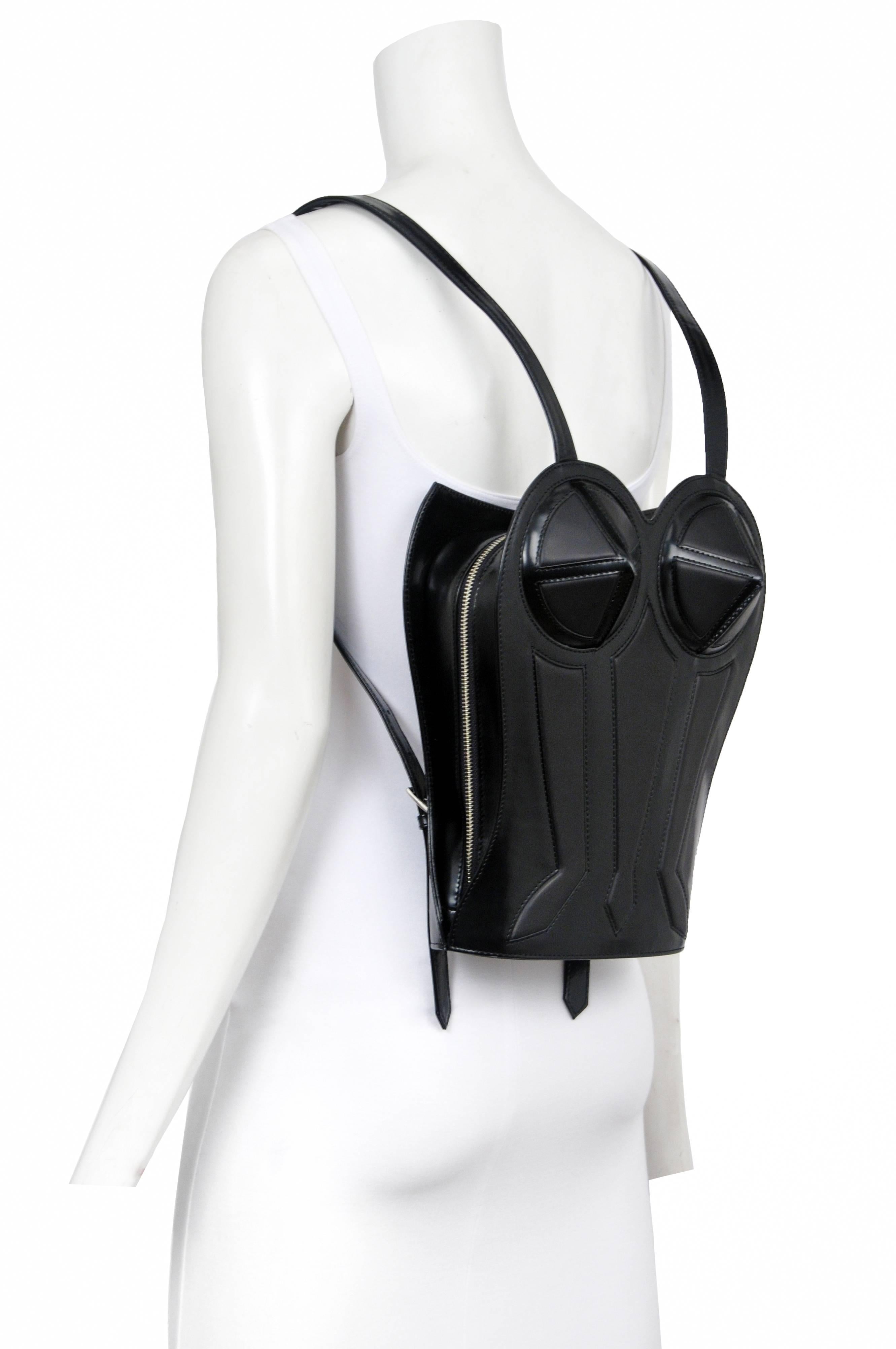 Vintage Jean Paul Gaultier black bustier backpack featuring a structured leather exterior with top stitching throughout and a fabric lined interior. Circa 1998.