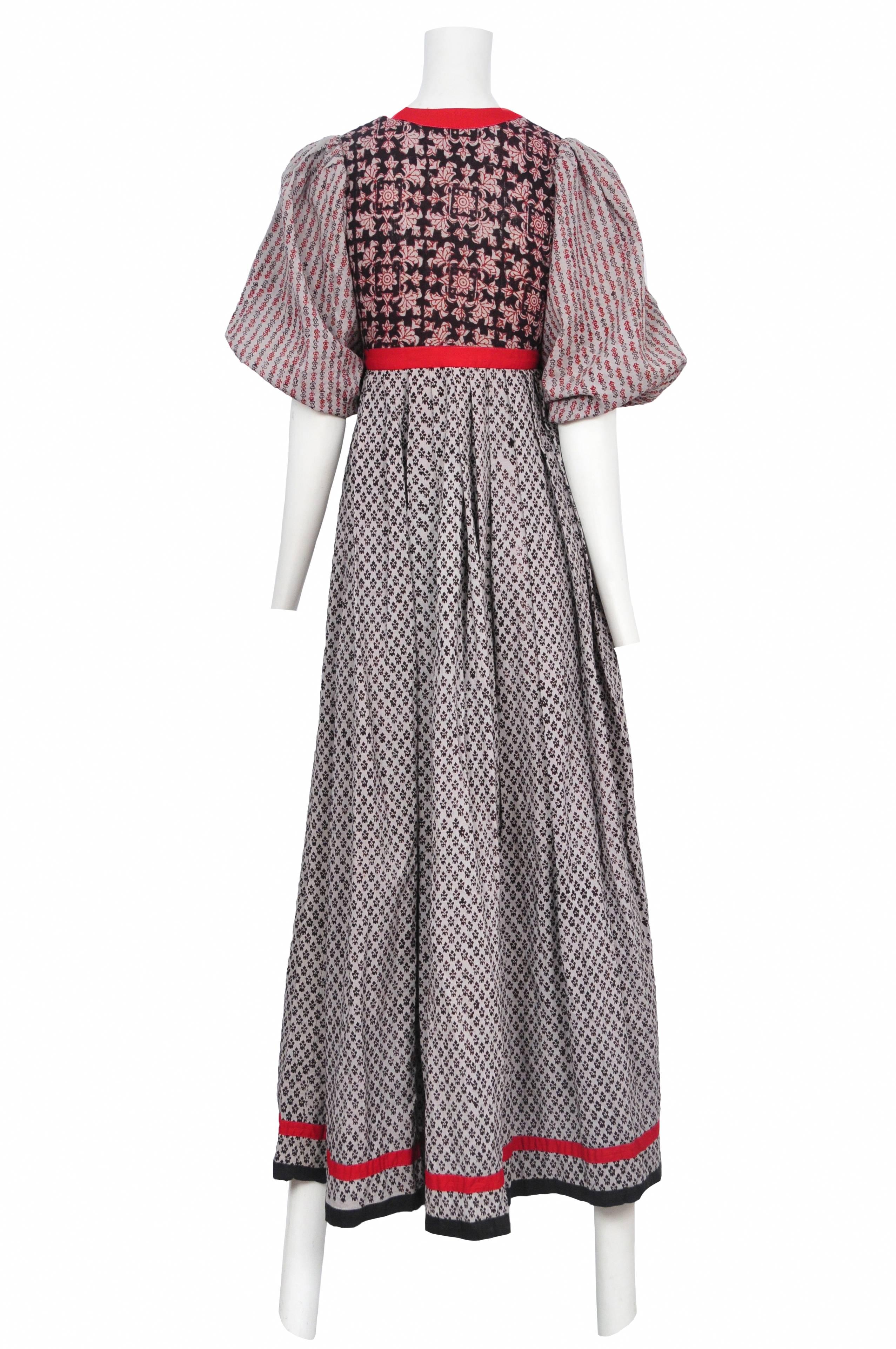 Vintage Thea Porter peasant dress featuring a bohemian chic print, plunging neckline, and empire waist. Circa 1970's.