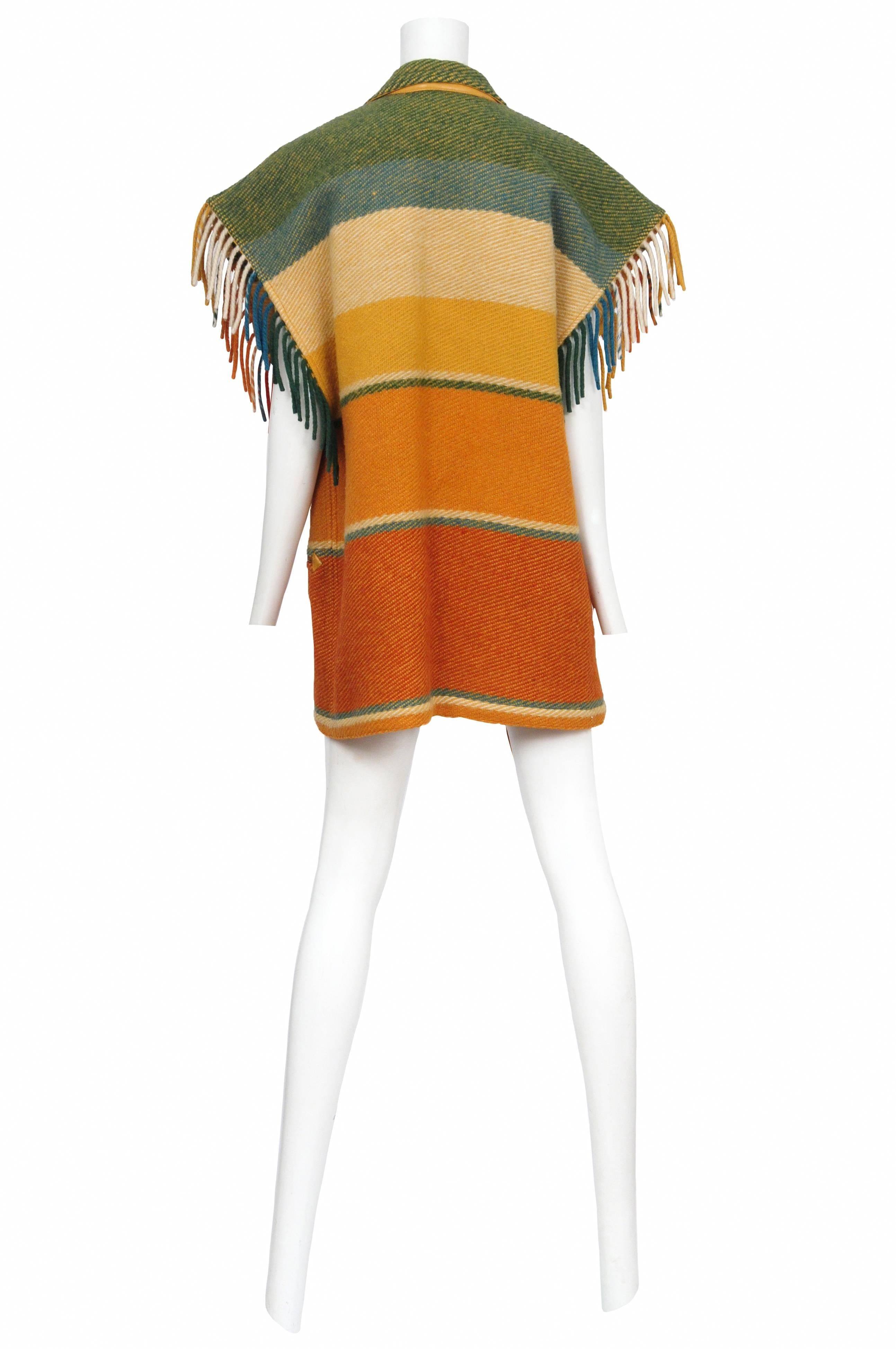 Vintage Jean Charles de Castelbajac orange, yellow and green stripe blanket vest featuring fringe along the collar and arm hole edges. 
