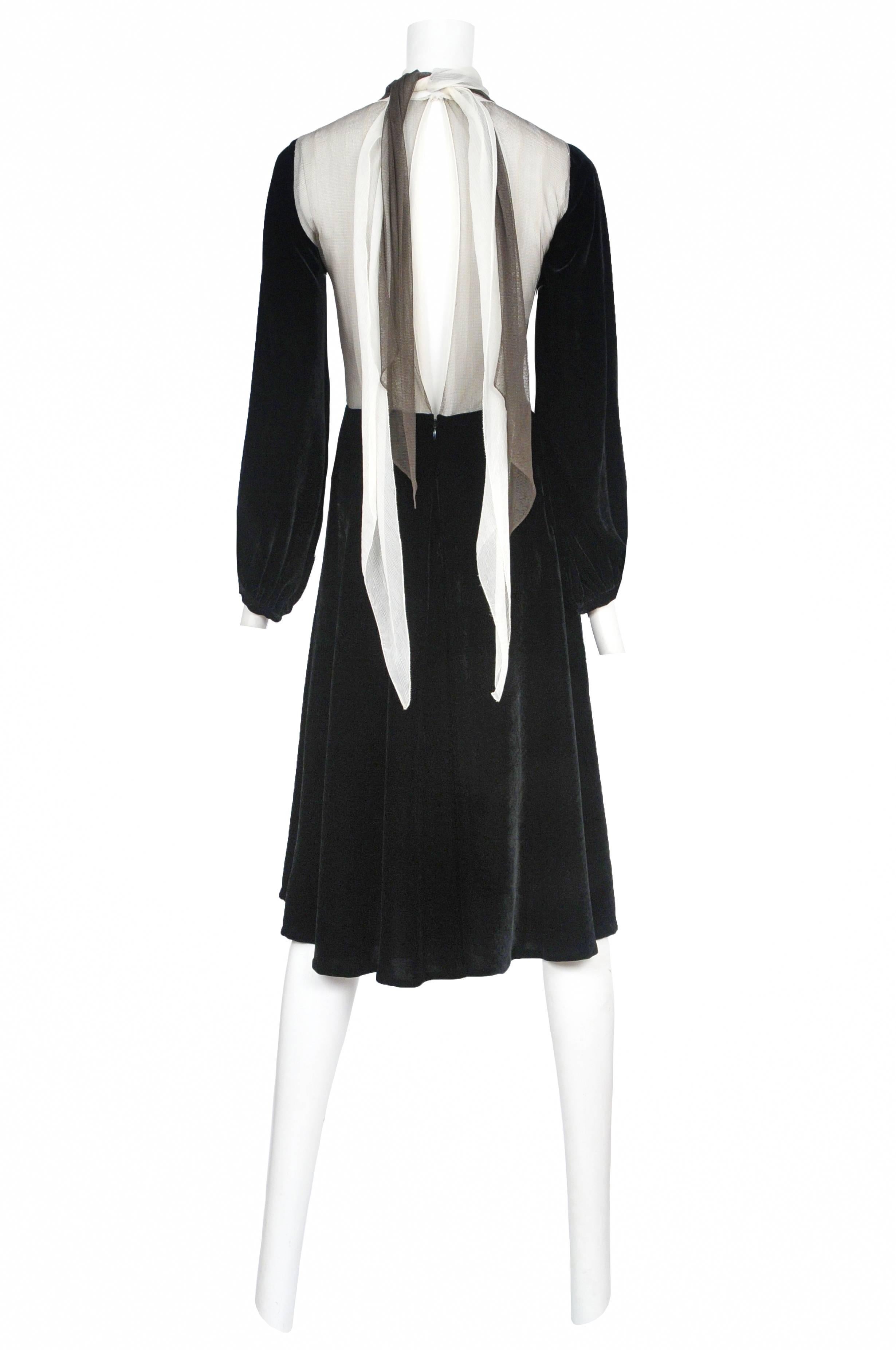 Vintage Jean Paul Gaultier black velvet dress featuring ivory mesh at the front torso, an ivory and black attached scarf that ties at the neck and a permanent heart shaped crystal brooch that hides under the mesh at the front chest.