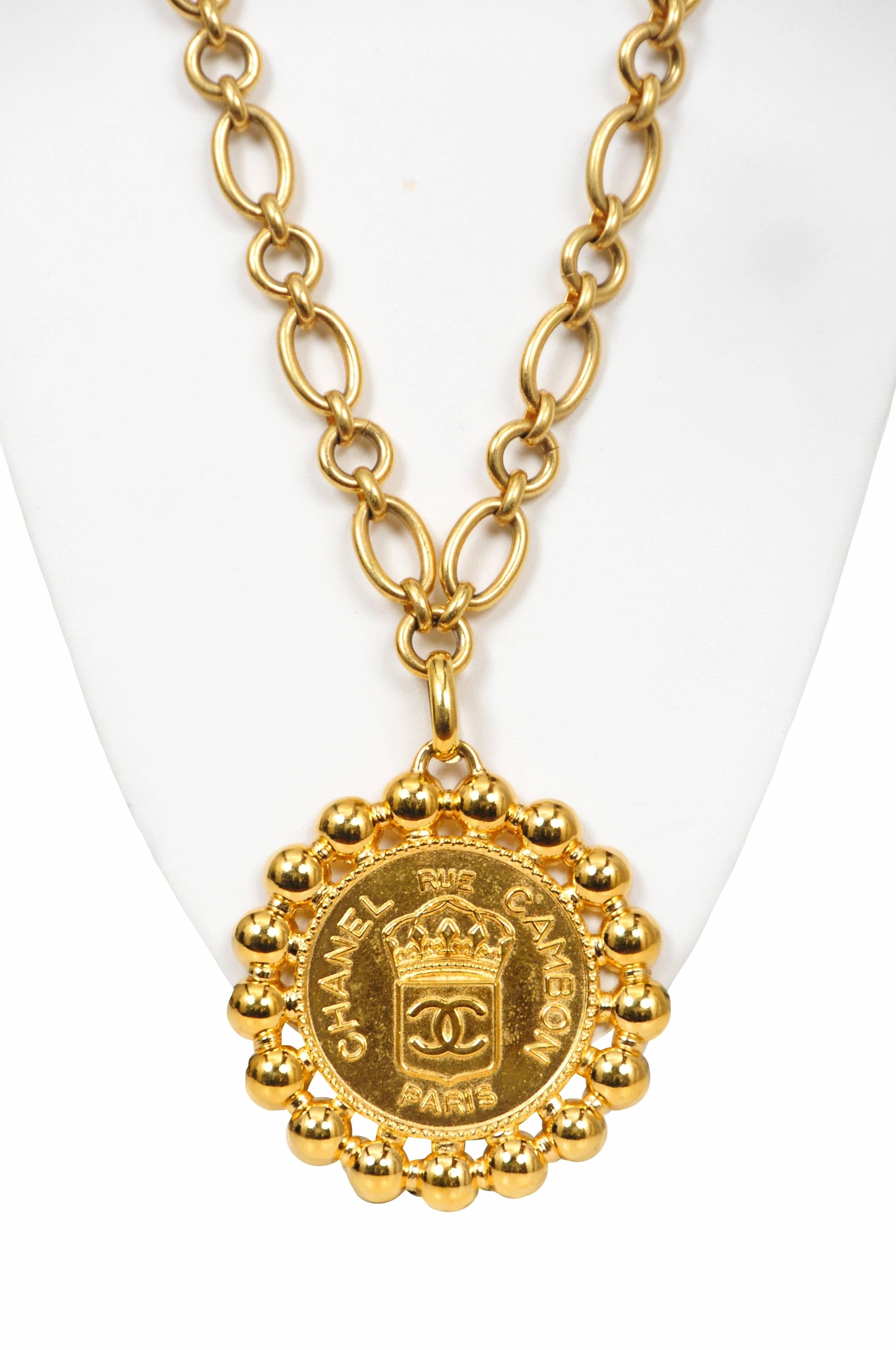 Vintage Chanel gold tone chain necklace featuring a medallion stamped with a Chanel royal seal. 