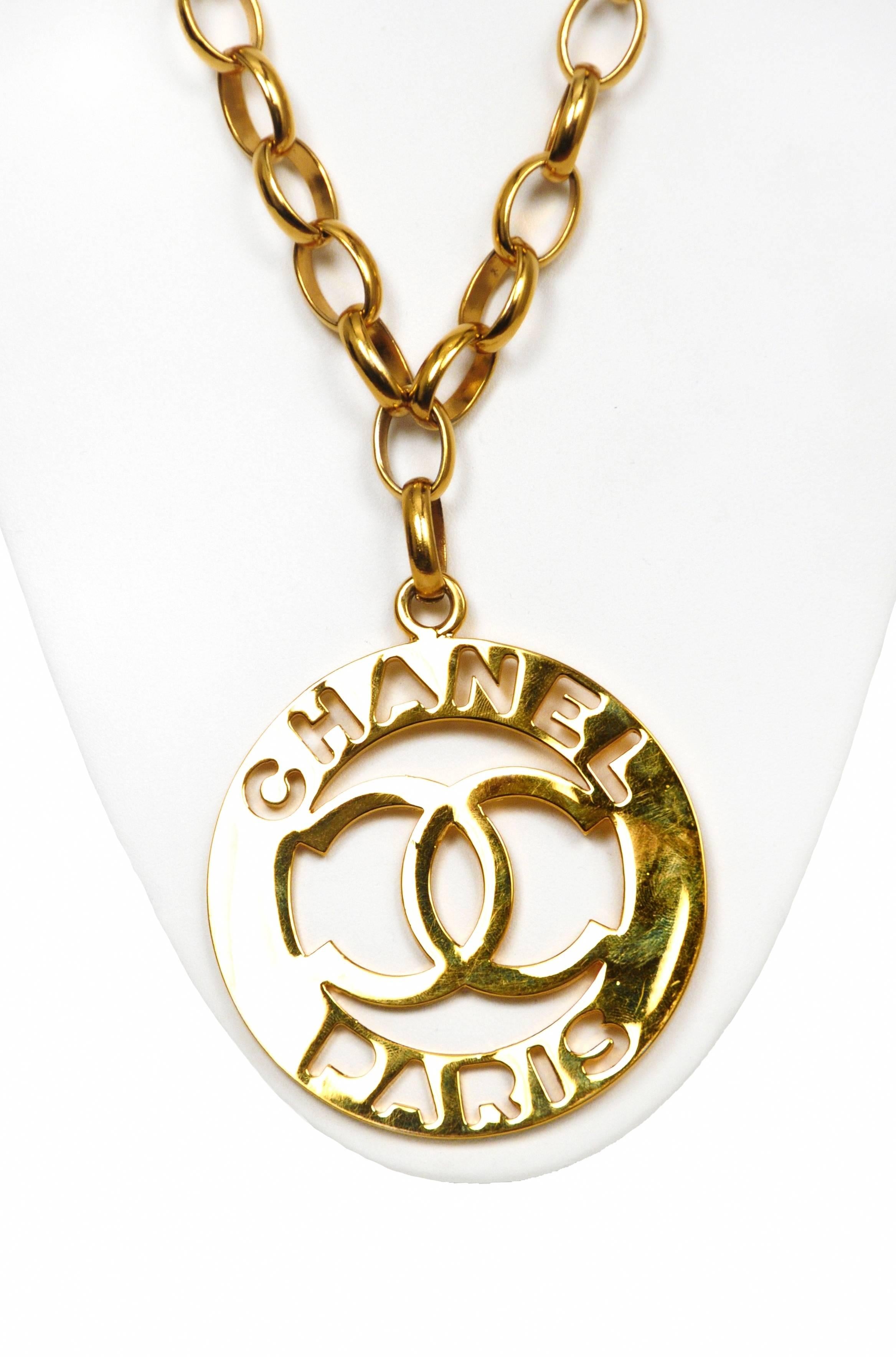 Vintage gold tone chain featuring a cutout medallion reading CHANEL PARIS with interlocking CC's in the center. 