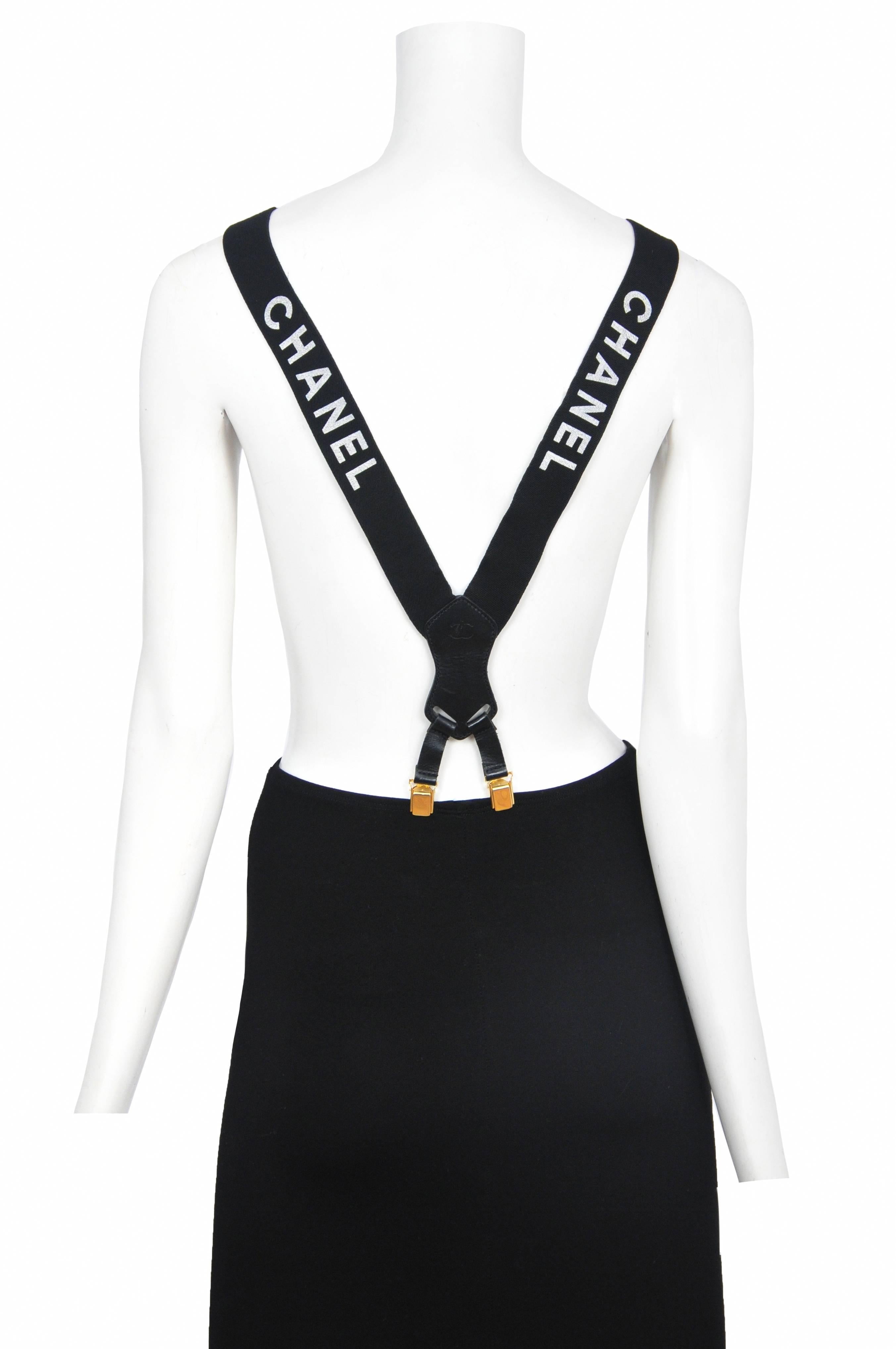 Chanel black suspenders with white Chanel logo.  