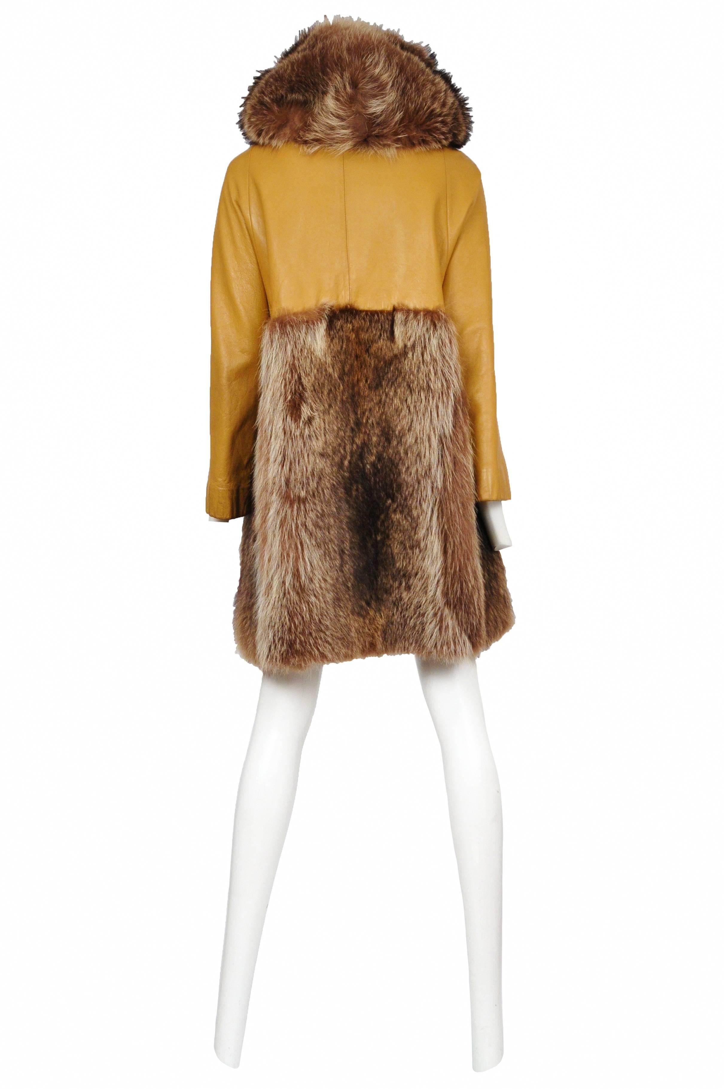 Vintage Bonnie Cashin mustard yellow leather coat featuring brass toggle closures, fur from the waist down and fur at the hood. 
