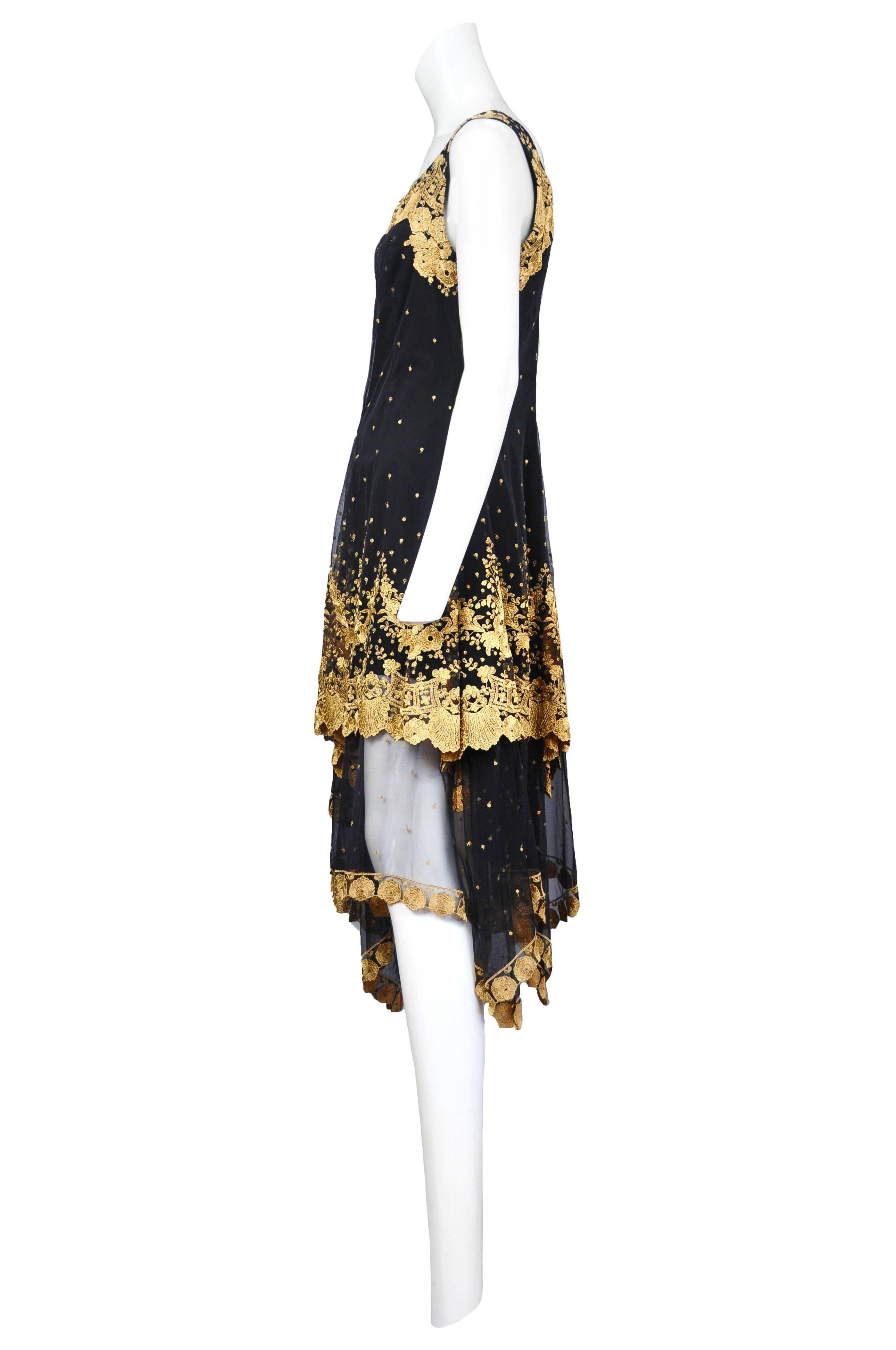 Vintage Christian Lacroix black sleeveless gown featuring gold embroidery throughout and a second sheer black tier at the hem, also adorned with gold embroidery.