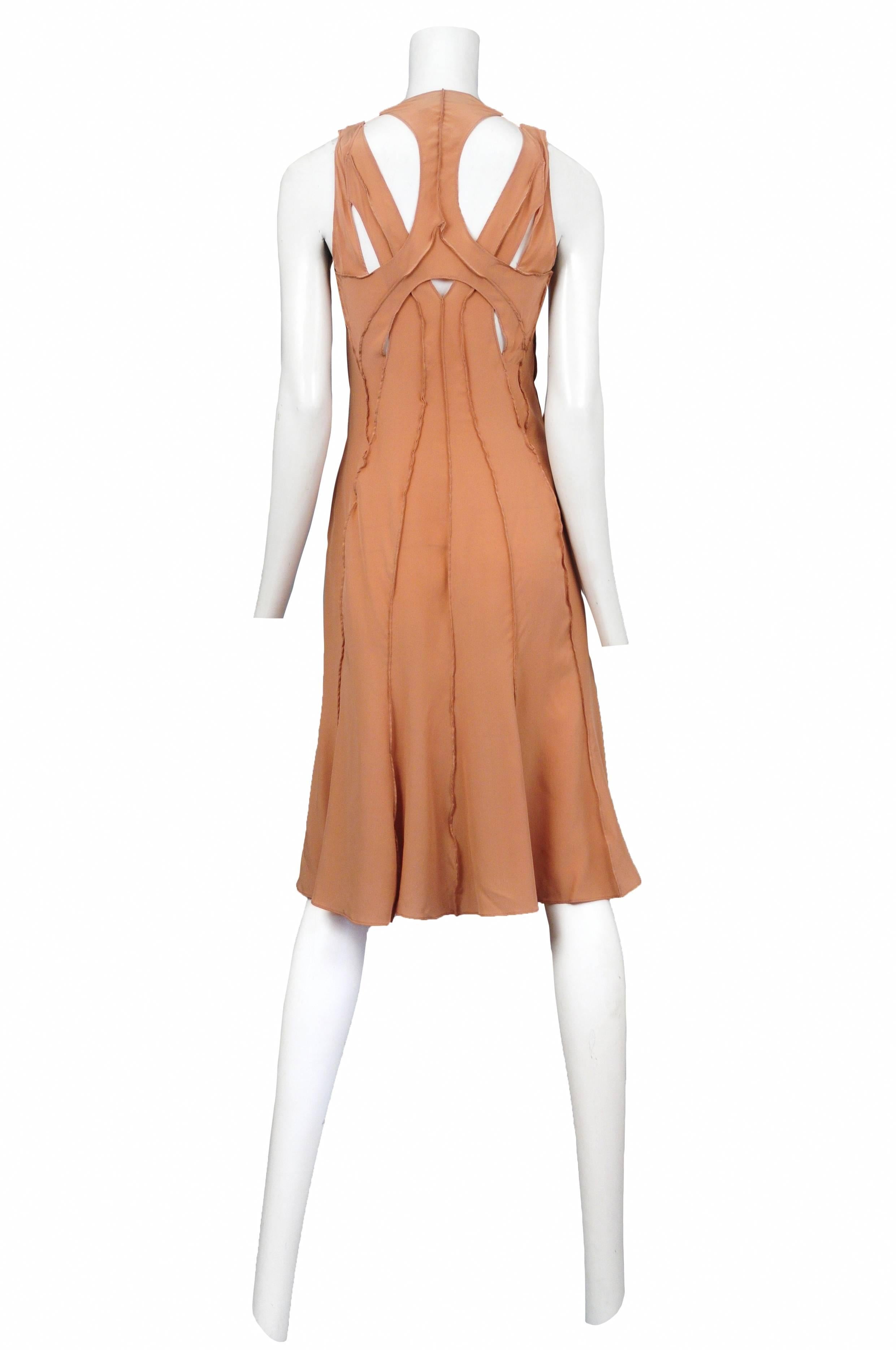 Vintage Tom Ford for Yves Saint Laurent peach silk sleeveless cocktail dress featuring cutouts, exposed seam detailing throughout and a large fabric rosette at the center chest. Runway piece from the Spring Summer 2003 Collection.