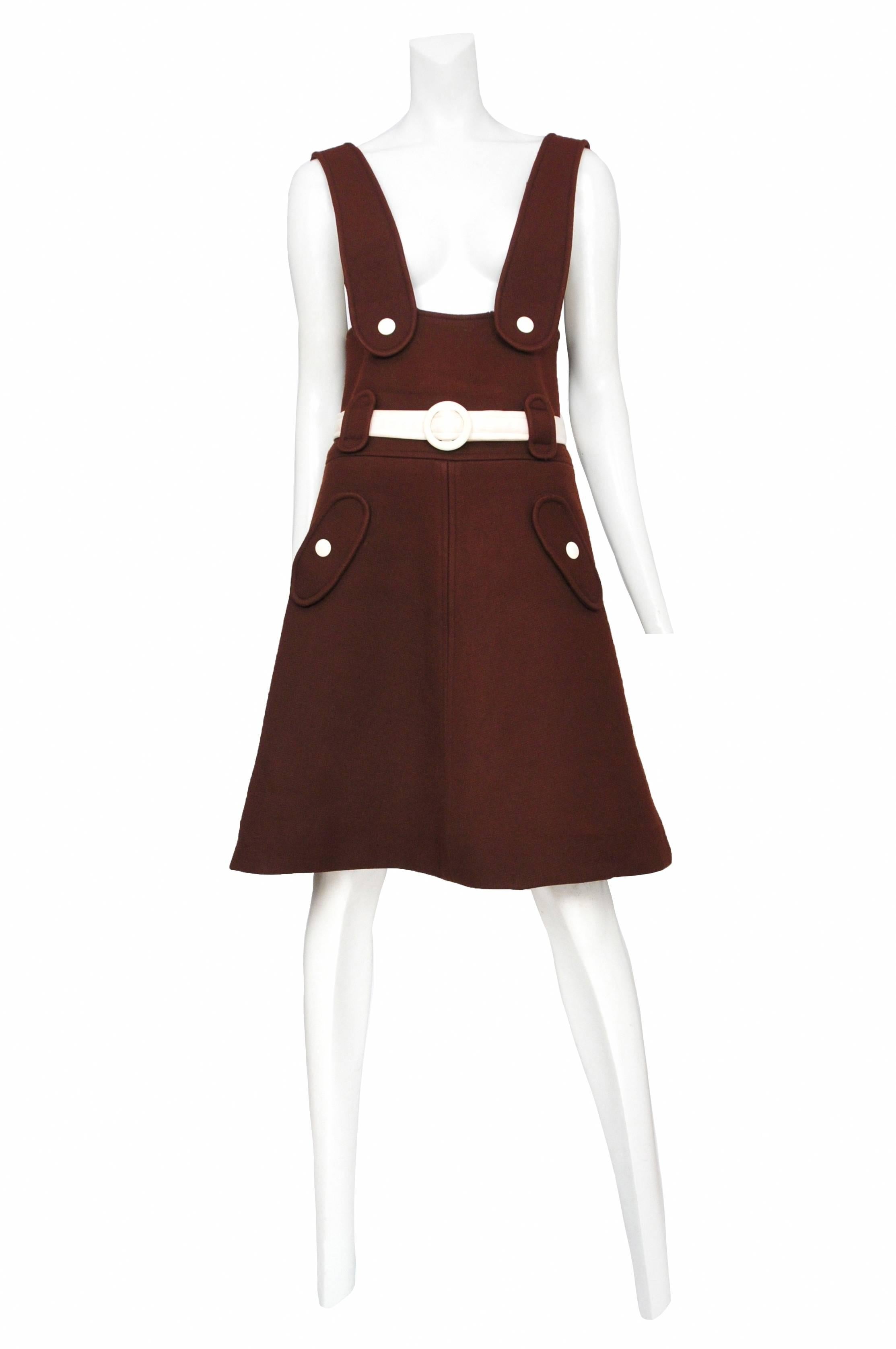Vintage Andre Courreges 1960's chocolate brown wool space-age jumper. A-line constructed skirt with side snap pockets and belted waist. The jumper features contrast white snap buttons and belt.