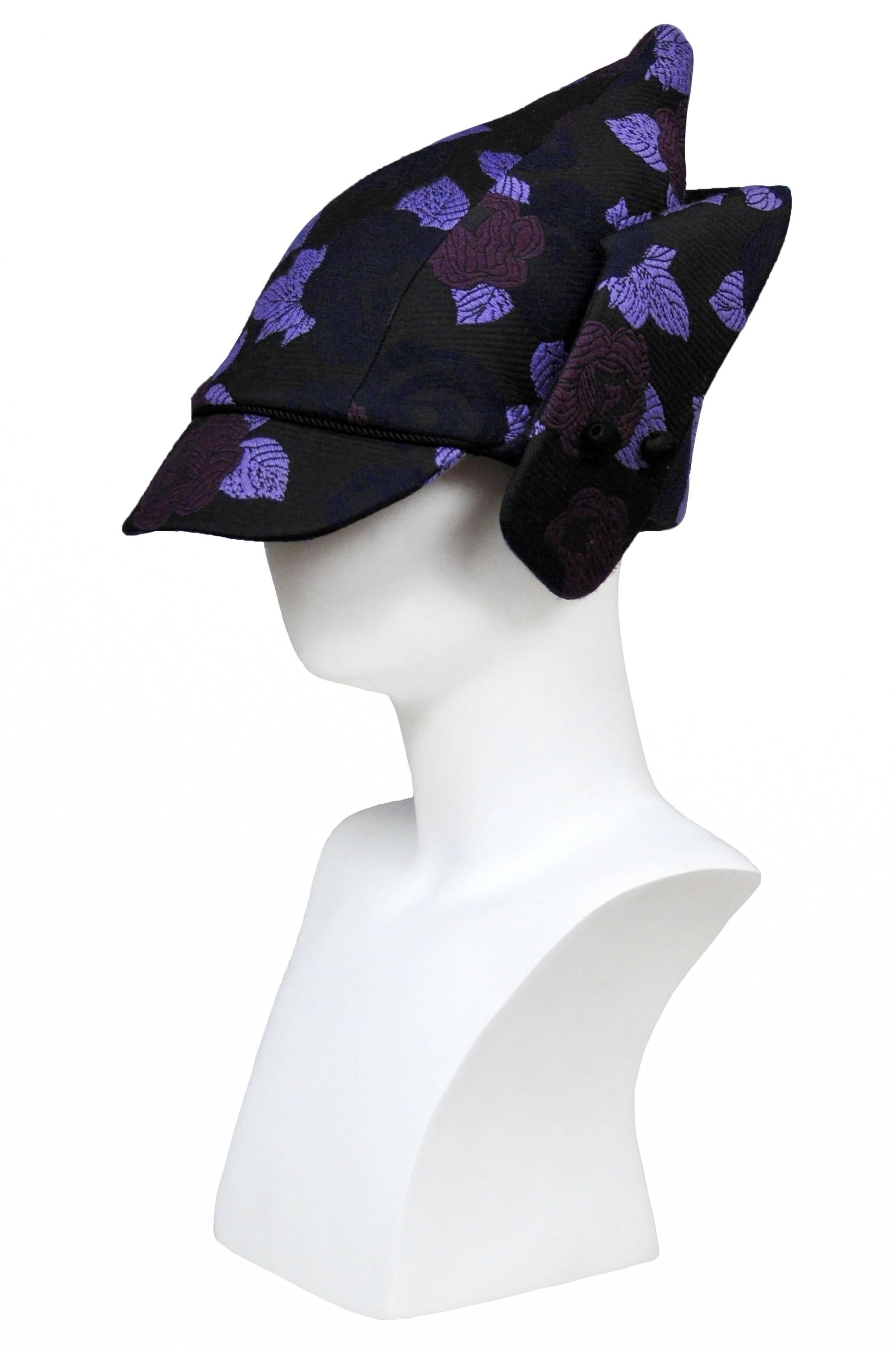 Vintage John Galliano for Christian Dior black hat featuring a pointed top, front brim and purple floral embroidery throughout. From the Fall 2009 Runway Collection.