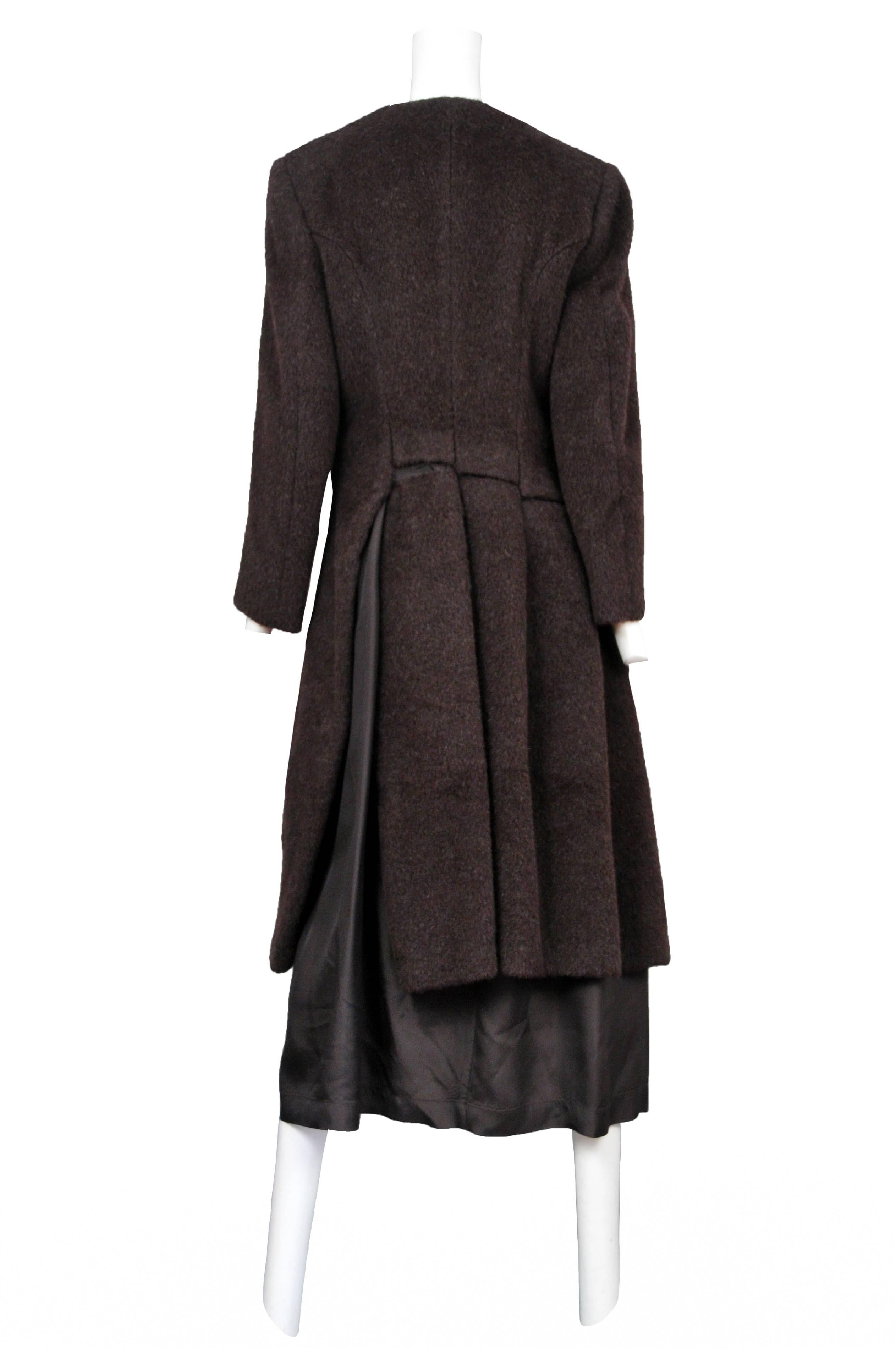 Vintage Comme des Garcons brown alpaca collarless coat featuring exposed brown lining at the hem and paneling at the back waist. Circa 1997.