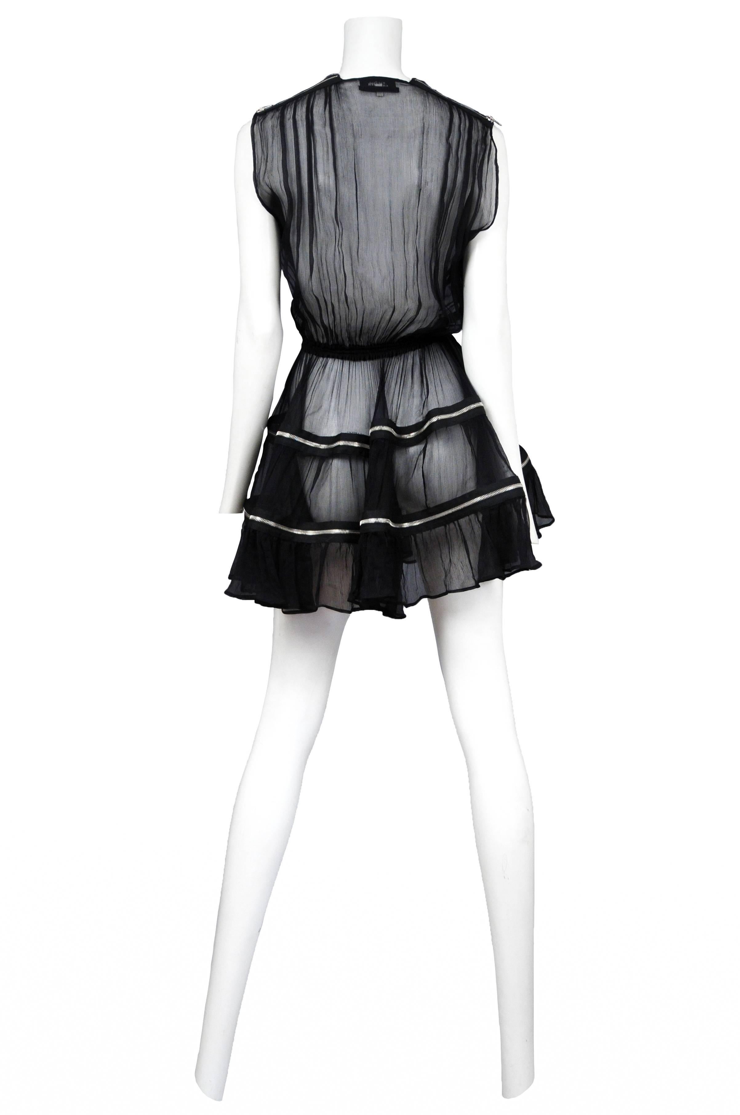 Vintage Jean Paul Gaultier black tulle dress featuring a plunging neckline, elastic waistband, and zippers at the shoulders and along each three tiers of the skirt. Sold with matching black slip.