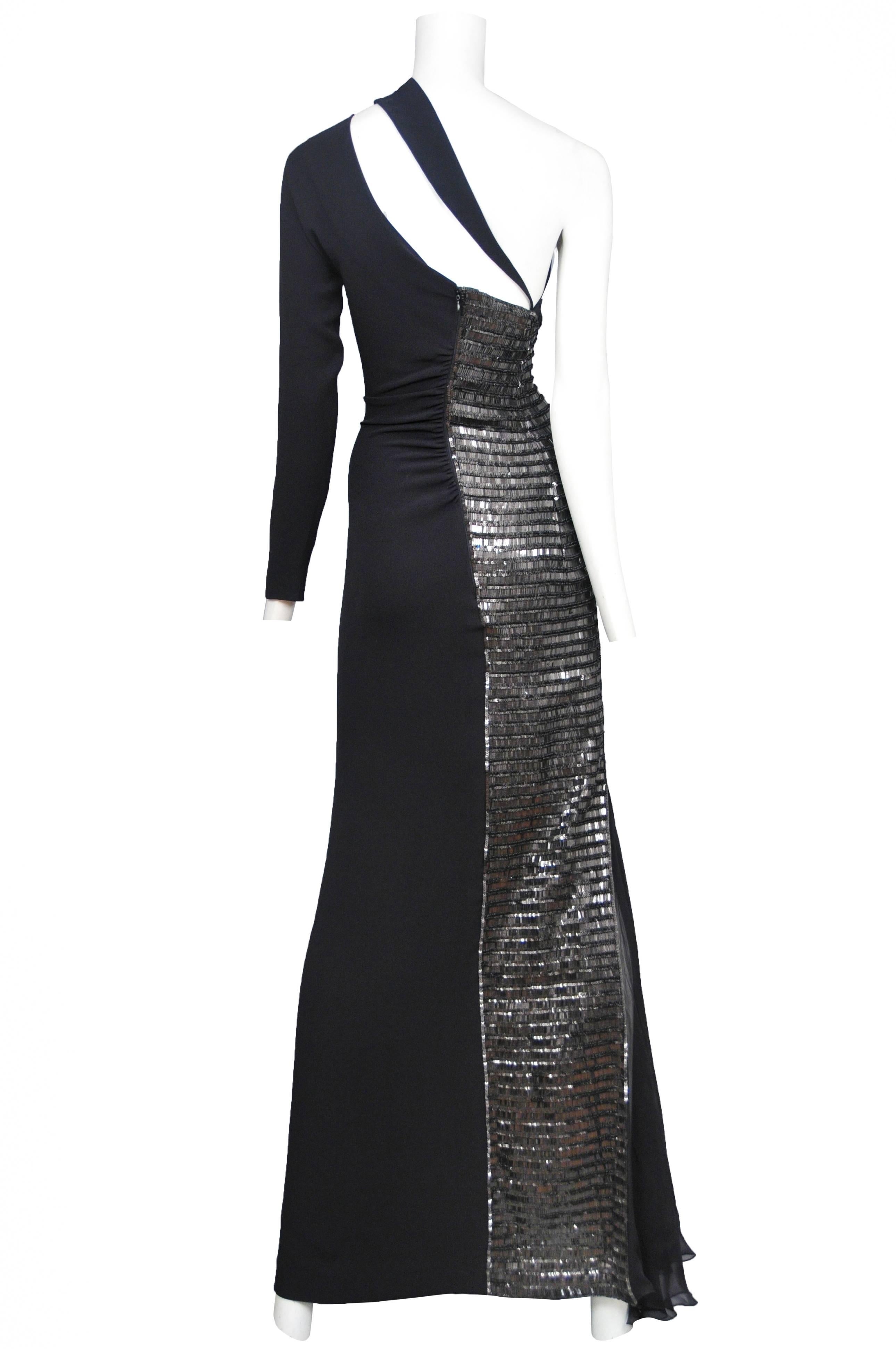 Vintage Gianfranco Ferre black silk and rayon jersey gown featuring an asymmetrical neckline with one long sleeve on the left, gunmetal beading all along the back right and side panel of the gown, and a black silk chiffon insert towards the bottom