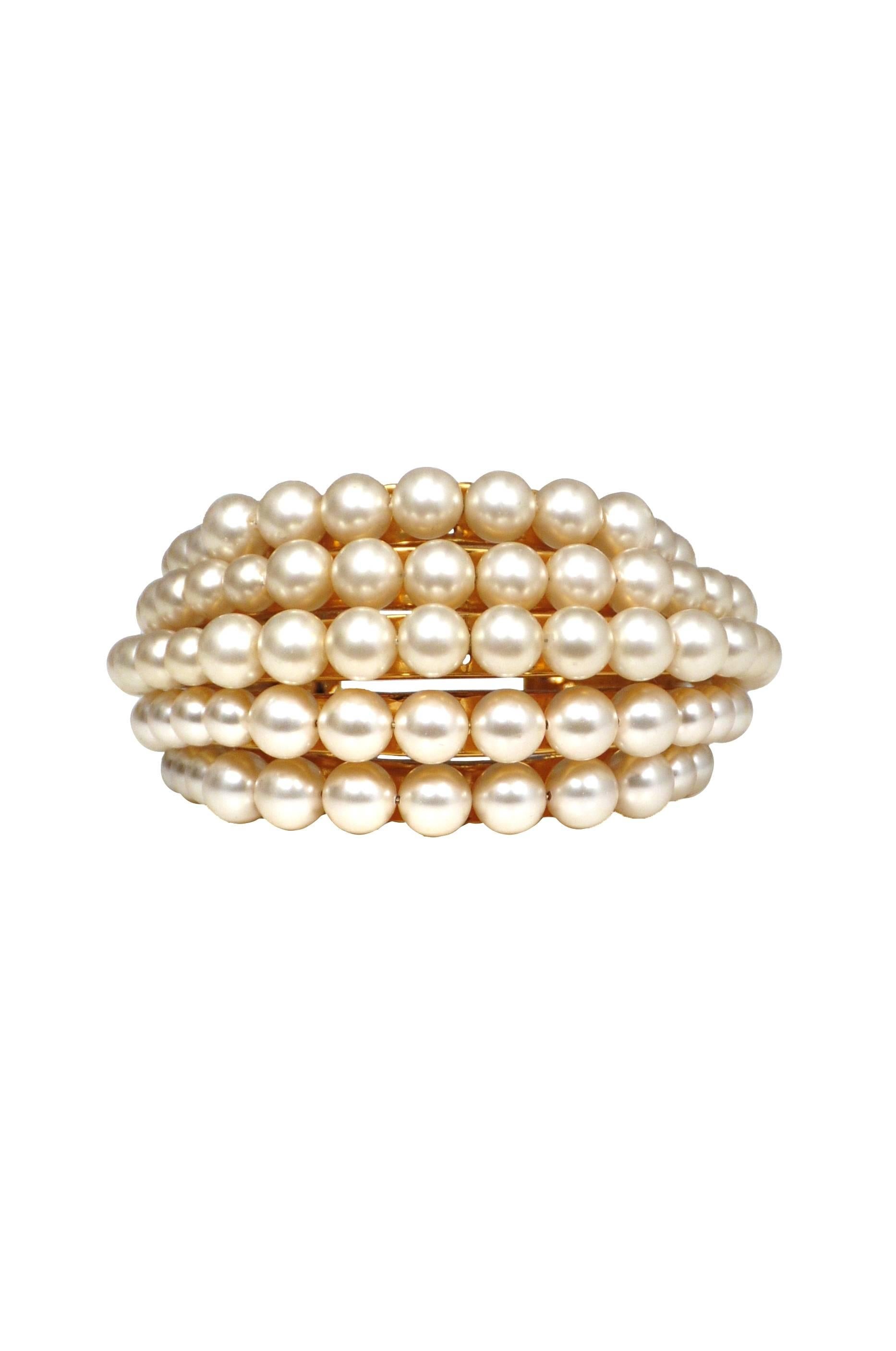 Vintage Chanel pearl bracelet featuring five rows of graduated faux pearls attached to a multi-tier gold tone cuff.