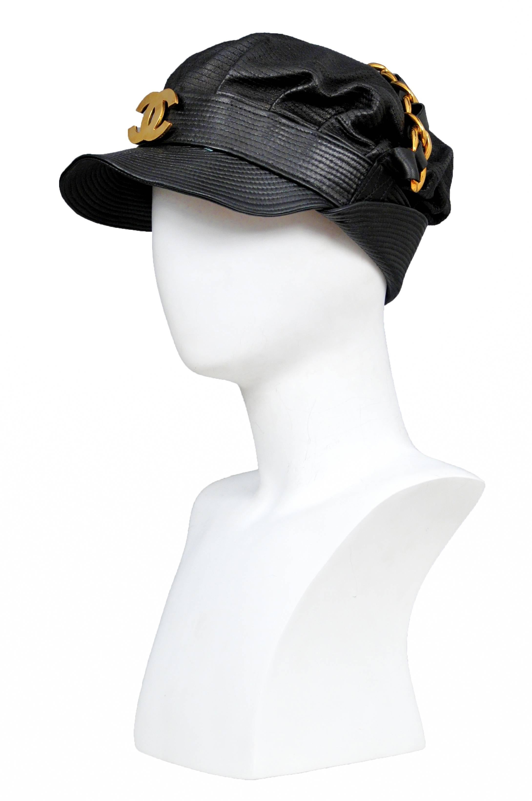 Vintage Chanel black leather biker hat with gold and leather braided chain across the top and a gold tone interlocking CC emblem at the center front. Please contact for additional photos. 