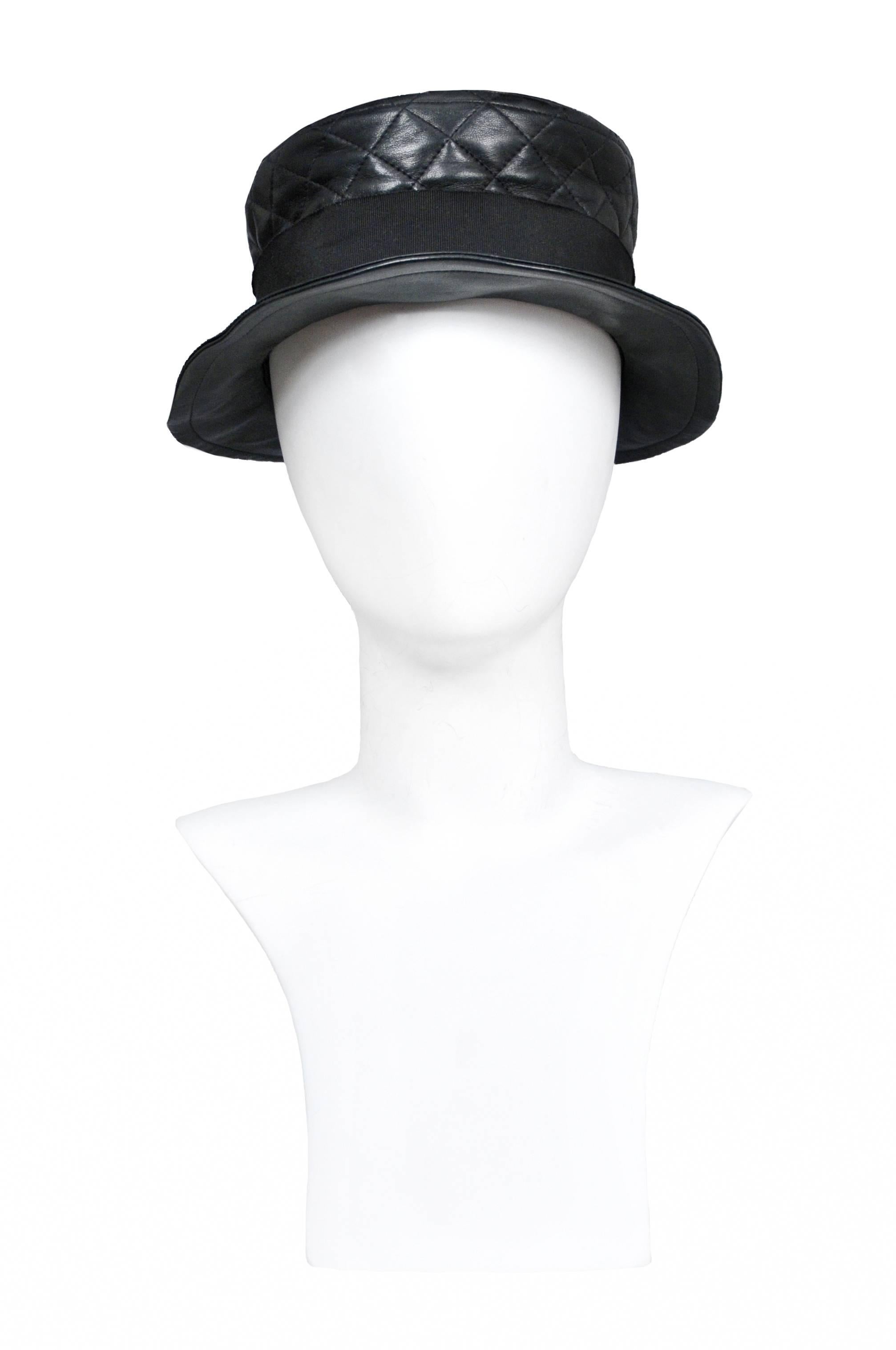Vintage Chanel black quilted leather hat featuring a brim that slightly turns up and a black grosgrain ribbon surrounding the crown. Runway piece from the 1993 Autumn / Winter Collection.