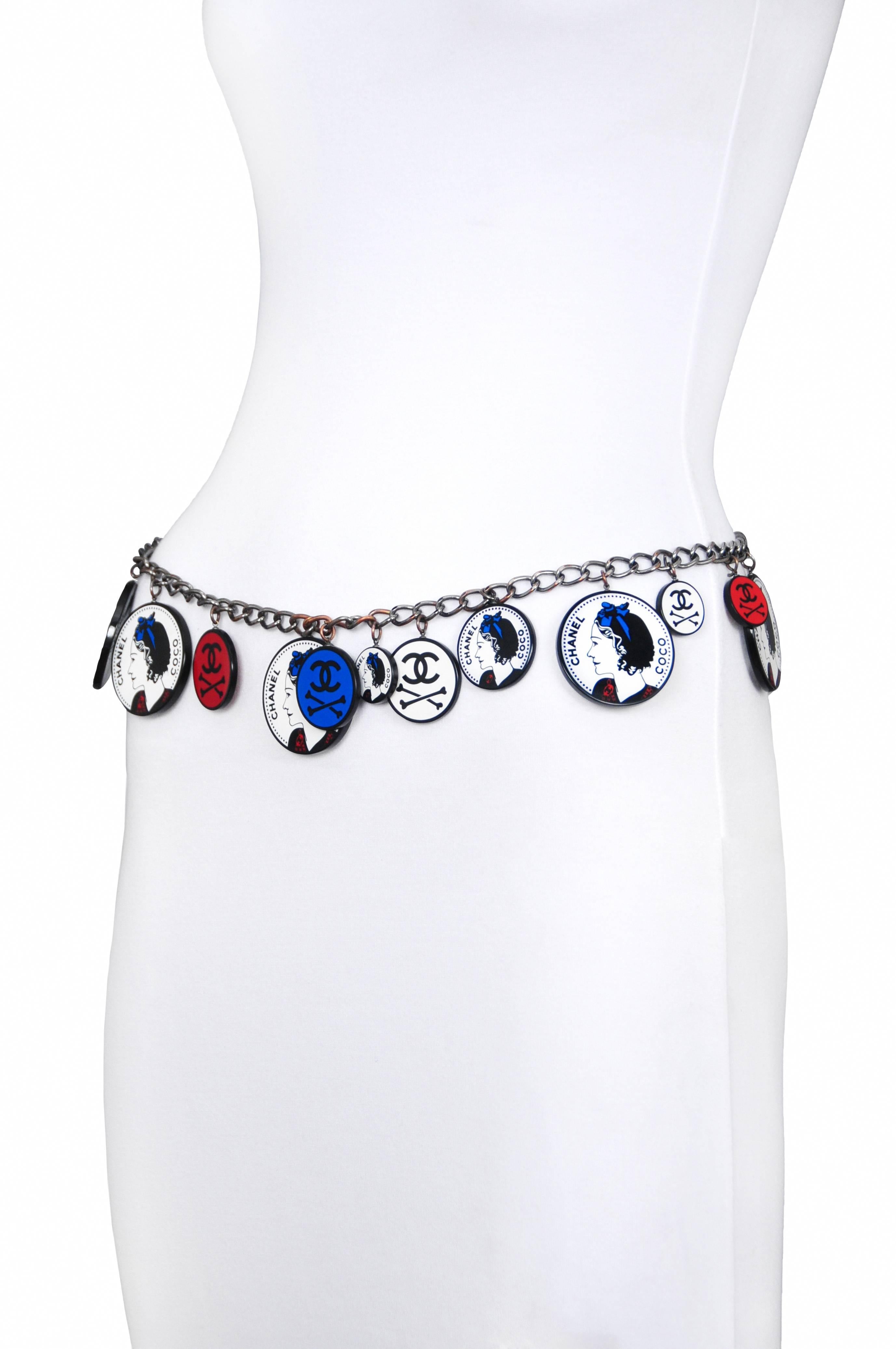Vintage Chanel belt featuring charms bearing the portrait of Coco Chanel herself using the colors red, white and blue mixed with red, white and blue charms decorated with iconic Chanel interlocking CC's and crossbones that hang from a silver tone