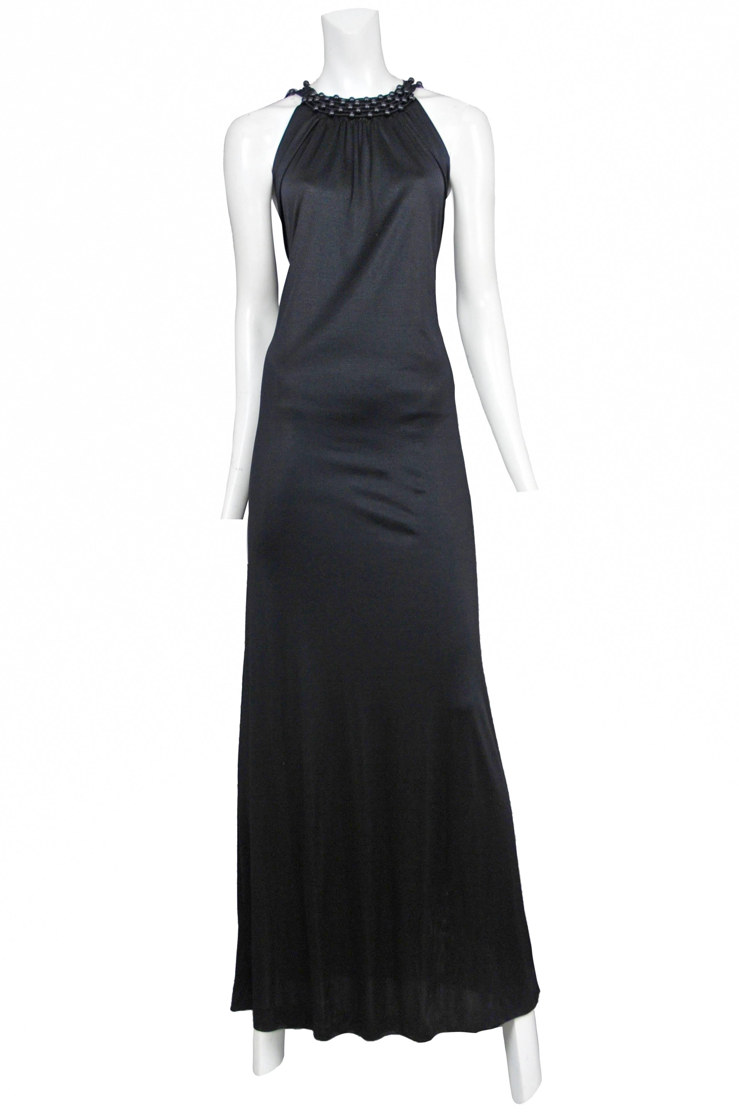 Loris Azzaro black jersey gown with open back lattice fringe work and wood bead detail. Circa 1971 