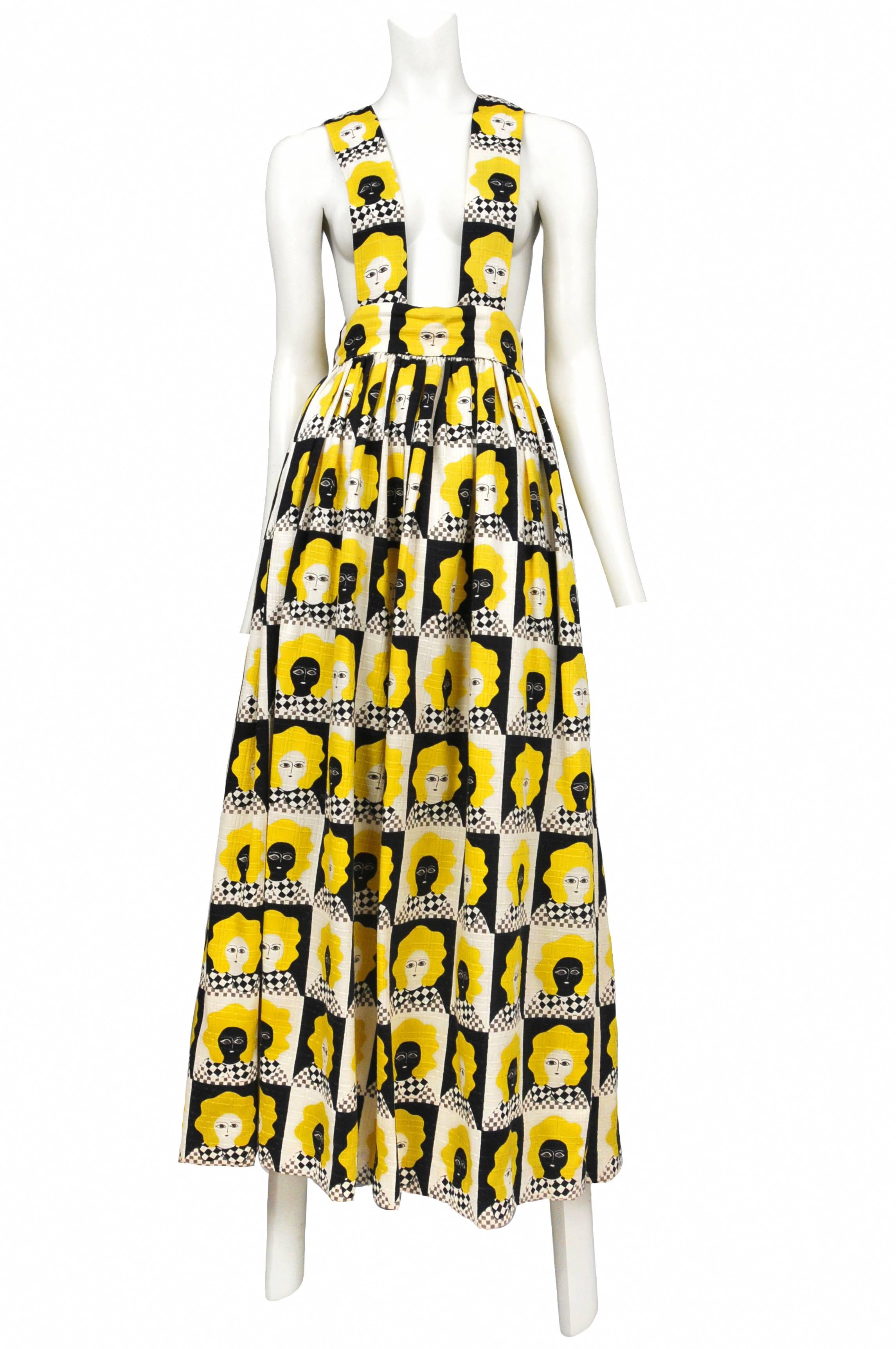Gloria Vanderbilt suspender romper with bright yellow, black and white checkered face cotton designed by Bill Tice. Dress features side pockets and  back zipper.  Circa 1970s
