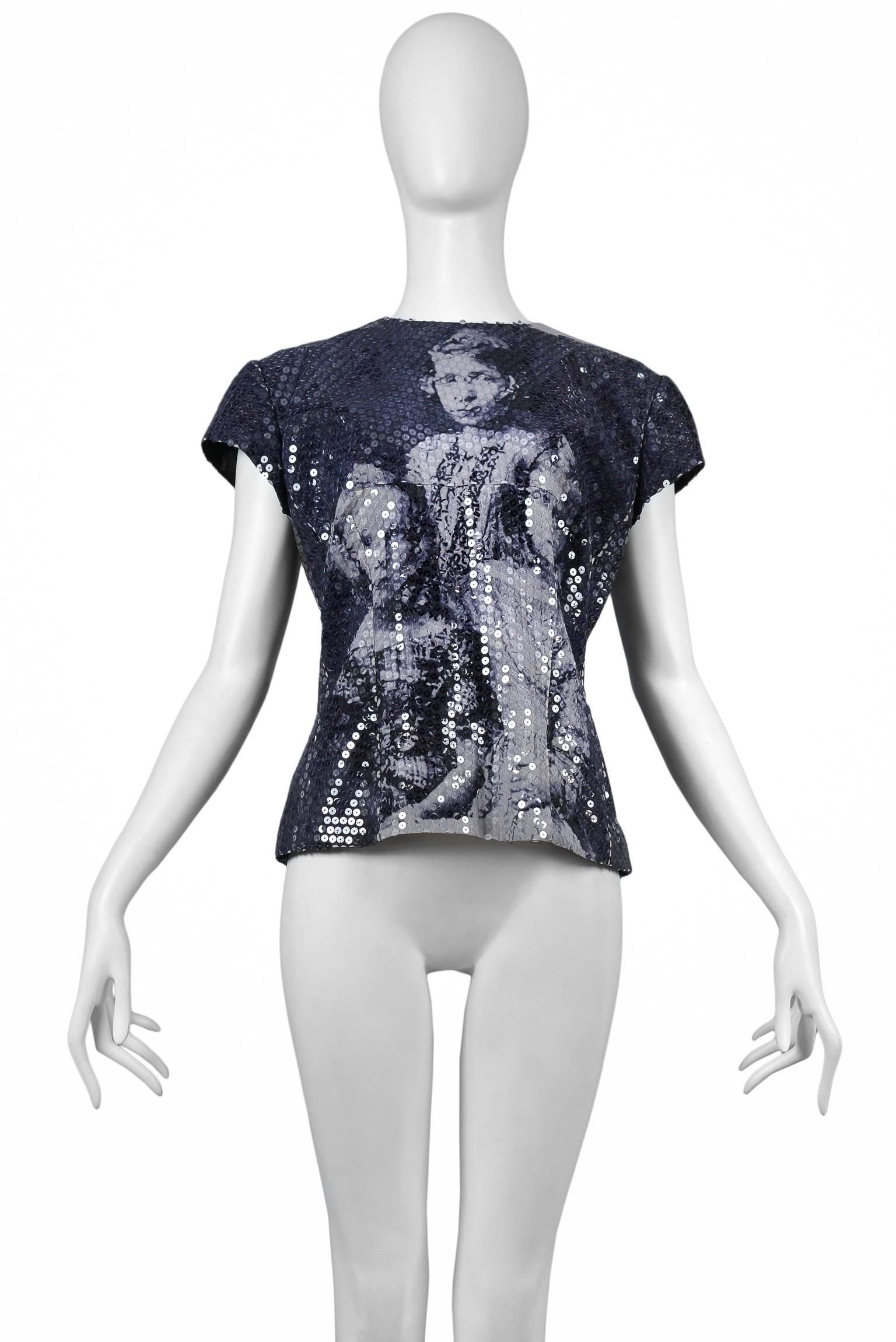 Resurrection Vintage is excited to offer an Alexander McQueen Romanov Children top from the Joan collection, featuring a high neck, short sleeves, iconic historical print of the Russian Imperial Romanov Children, fitted bodice, and center back