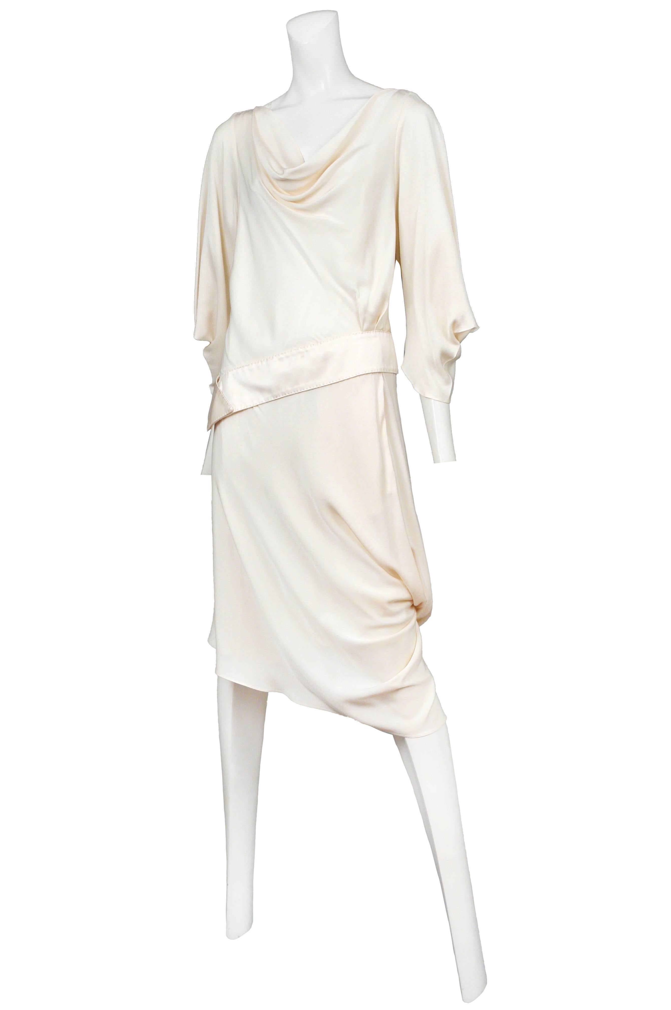 Off white kimonoesque dress with asymmetrical sash, draped skirt and bubble hem. Circa 2007.