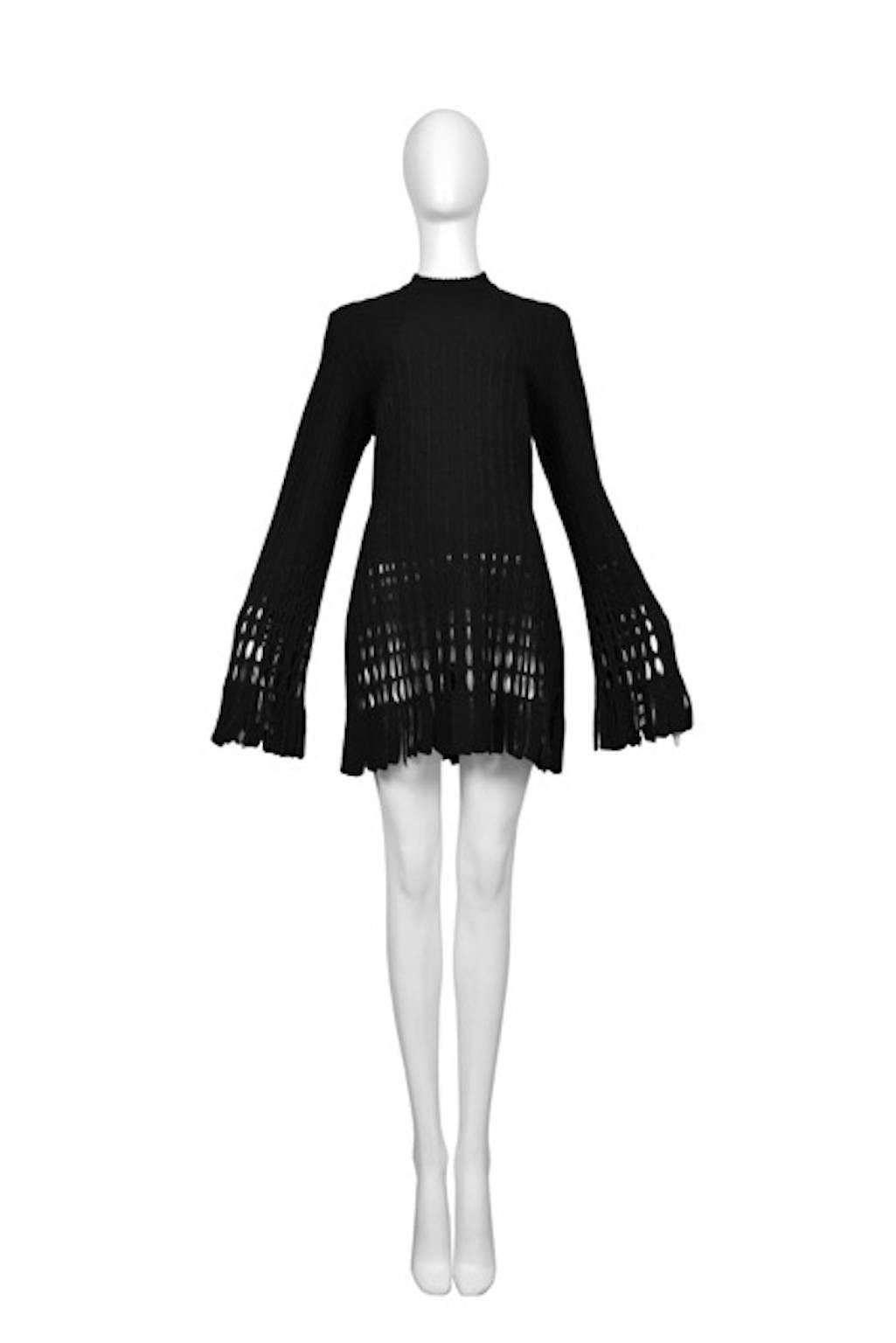 Vintage Azzedine Alaia black long sleeve mini knit dress featuring an open weave design at the cuffs and skirt.

Please contact us for additional photos.