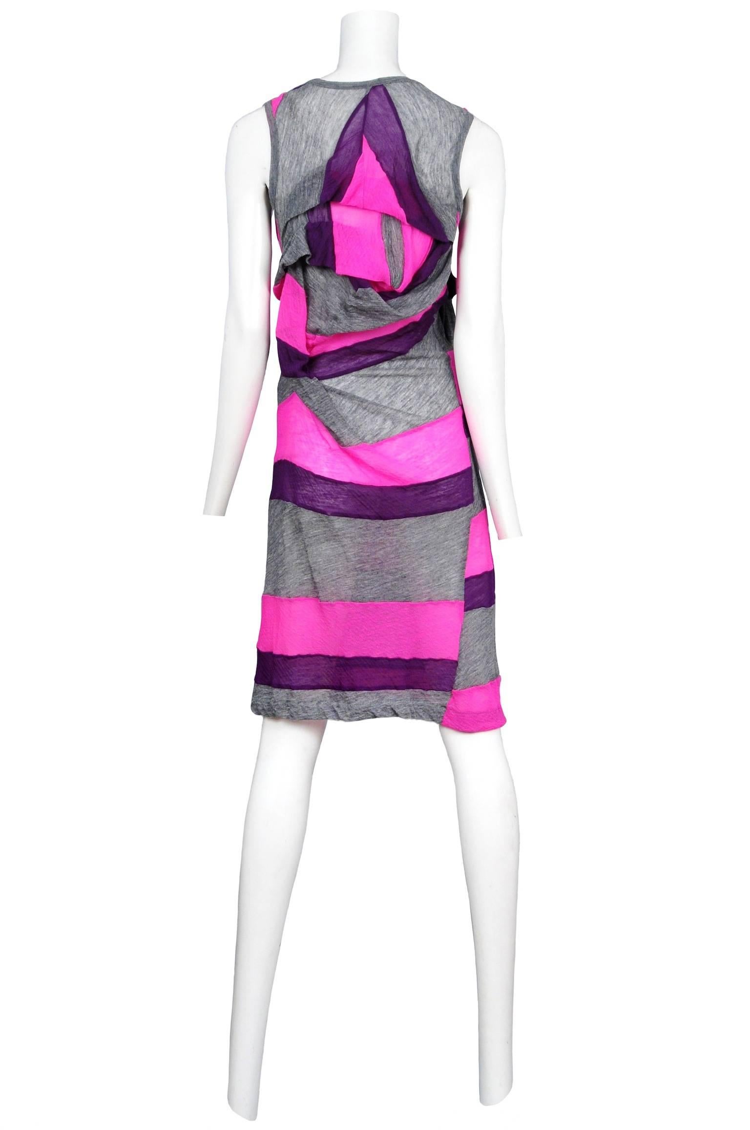 Vintage Comme des Garcons sleeveless heather grey knit dress featuring stripes of pink and purple and abstract ruffles that drape at the chest and center back. Circa 1995.

Please contact us for additional photos.