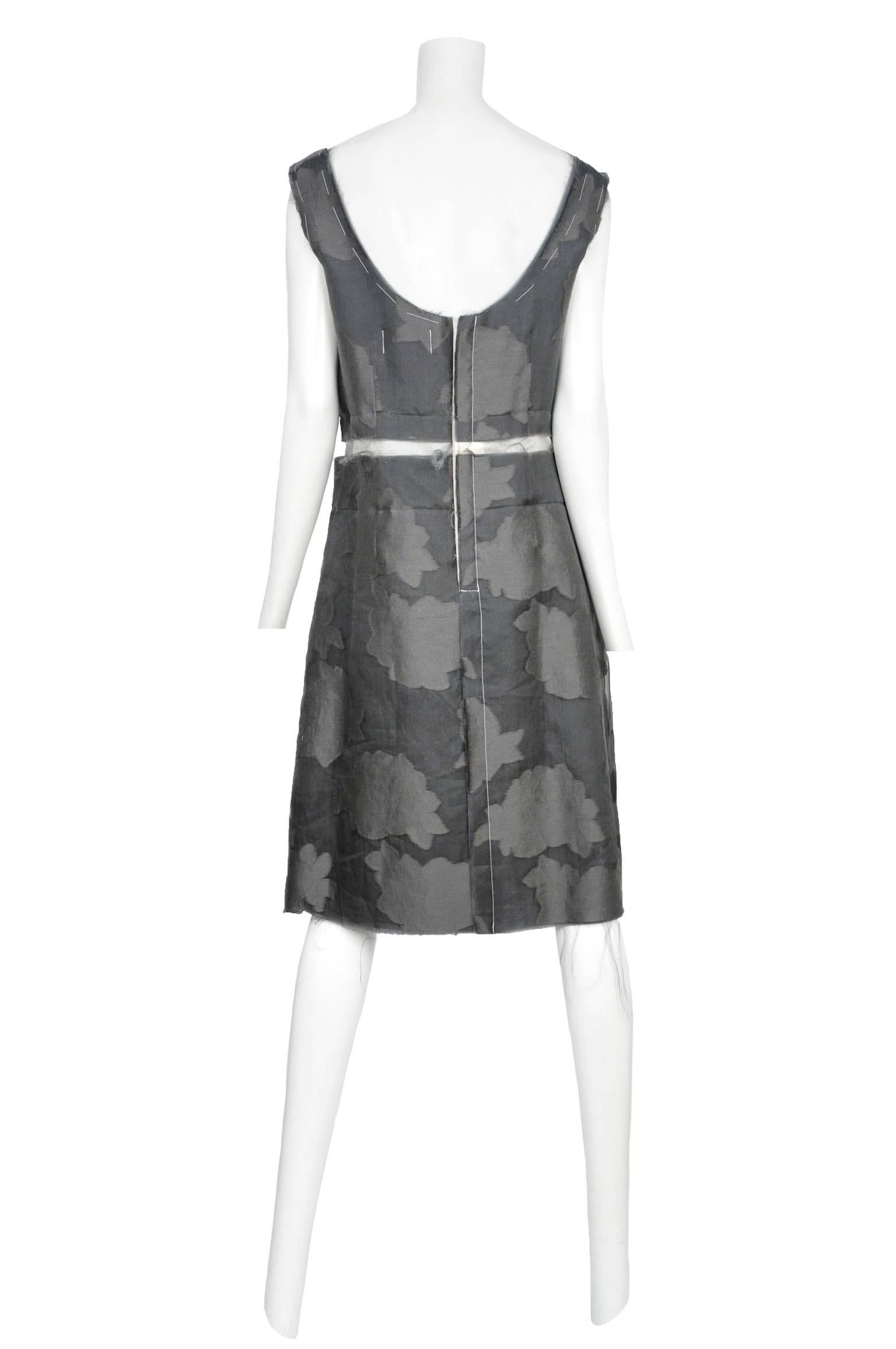Vintage Comme des Garcons sleeveless grey floral silk damask shift dress featuring exposed darts at the front and white mesh panel around the waist. Circa 1998.

Please contact us for additional photos.