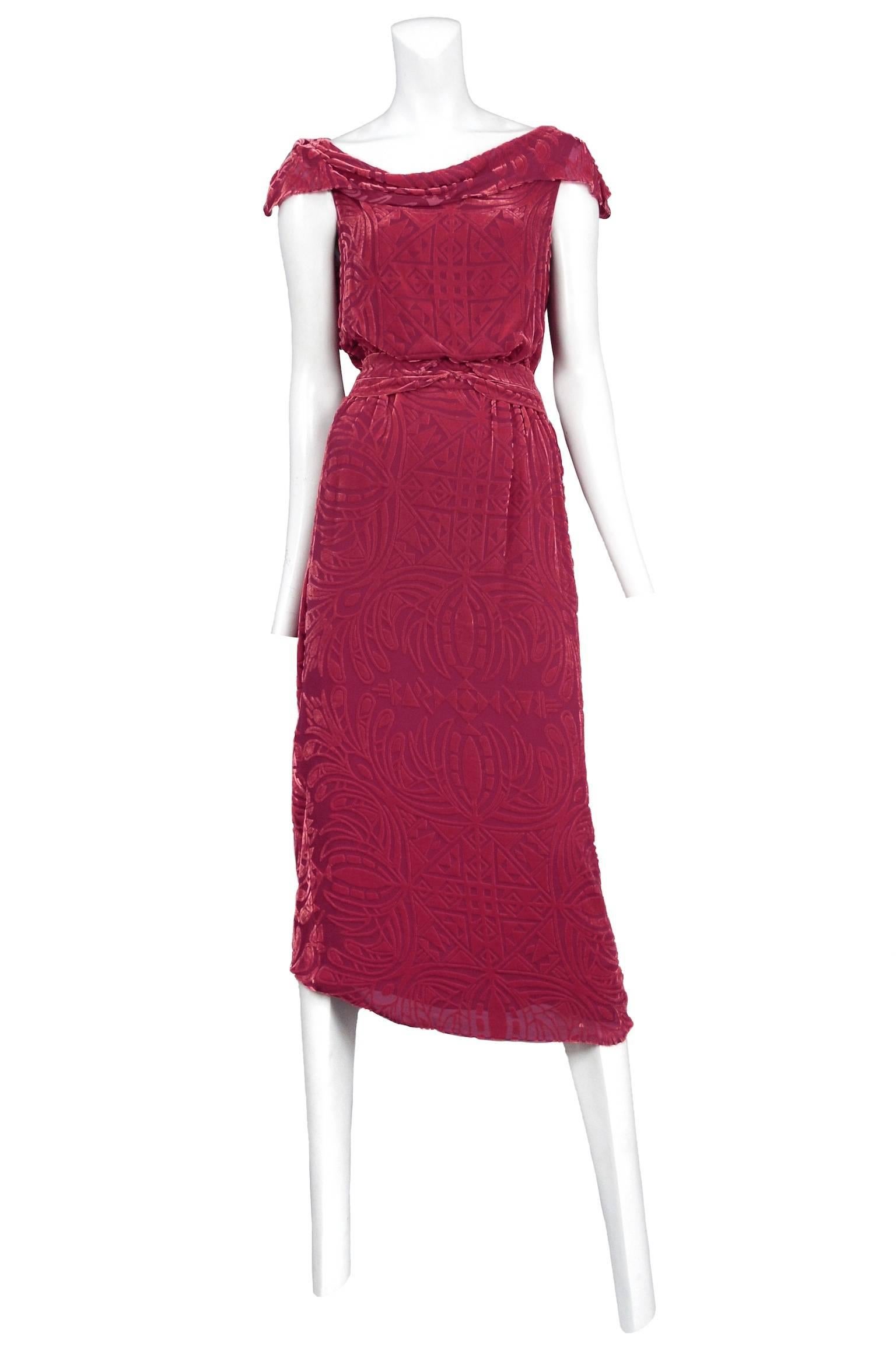 Vintage John Galliano red velvet devore below the knee dress featuring a draped neckline that hangs slightly over the shoulders, a fitted waist and an allover burnout design.

Please contact us for additional photos.
