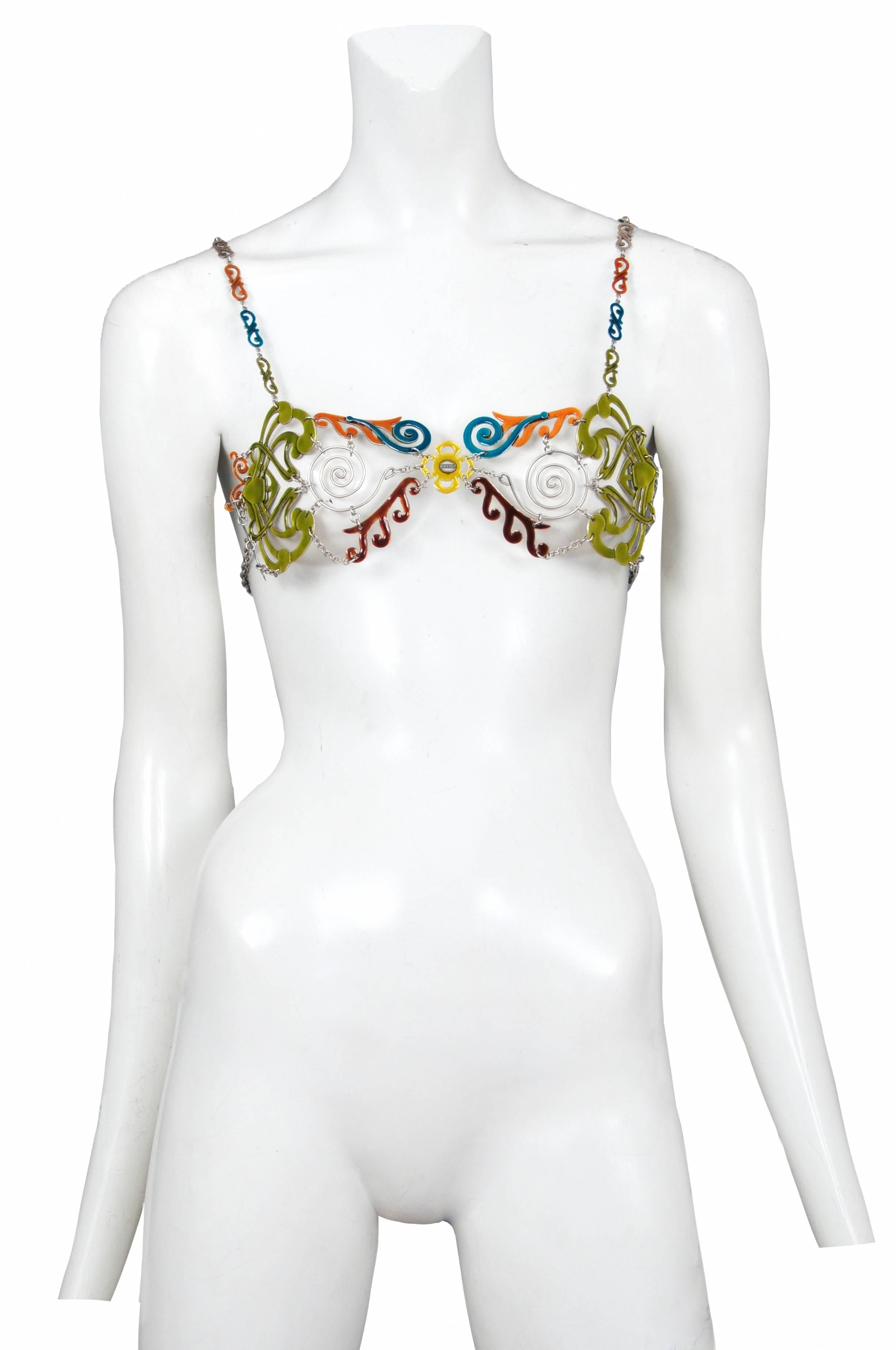Vintage Jean Paul Gaultier metal wire bra featuring aqua, olive, orange and rust enamel decorating segments of the metal and a Gaultier stamp at the center of the bra.
Bust 32-36in
Please inquire for additional images.