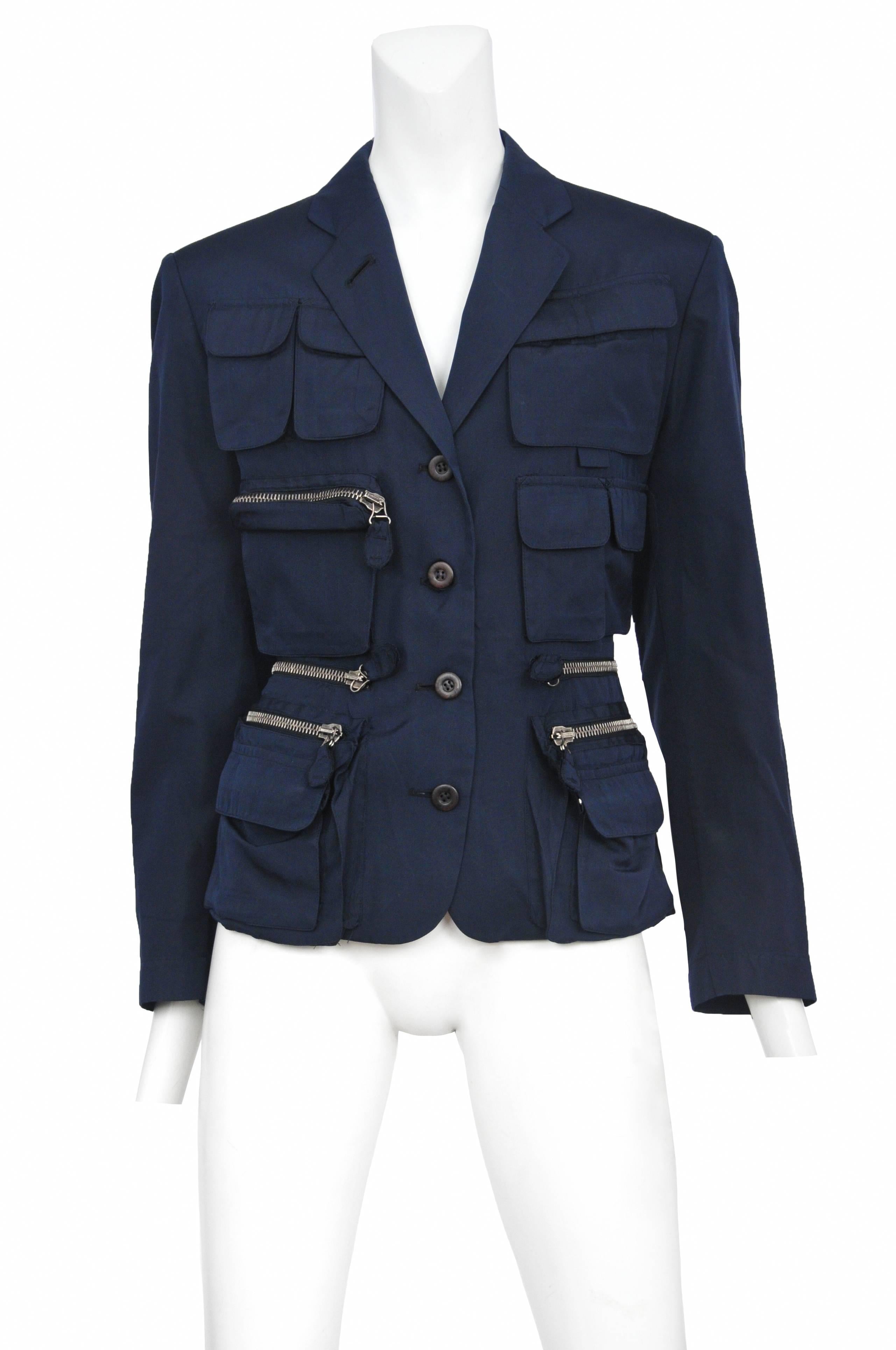Vintage Jean Paul Gaultier blue utilitarian 4 button blazer featuring multi-sized pockets with and with out zippers covering the front torso and chest.

Please inquire for additional images.
