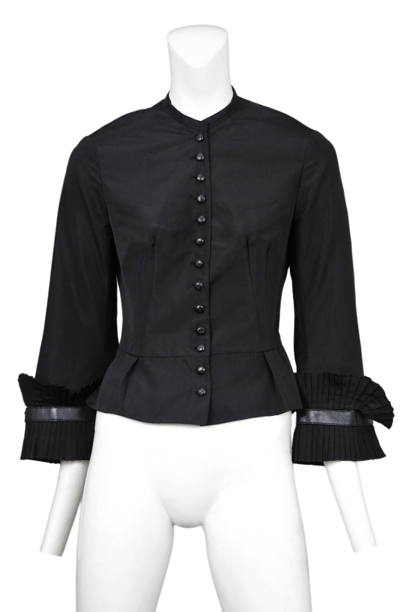 Vintage Alexander McQueen fitted black taffeta jacket with pleated sleeve trim and 13 front buttons. From the Supercalifragilisticexpialidocious Autumn / Winter 2002 Collection.

Please contact us for more photographs. 