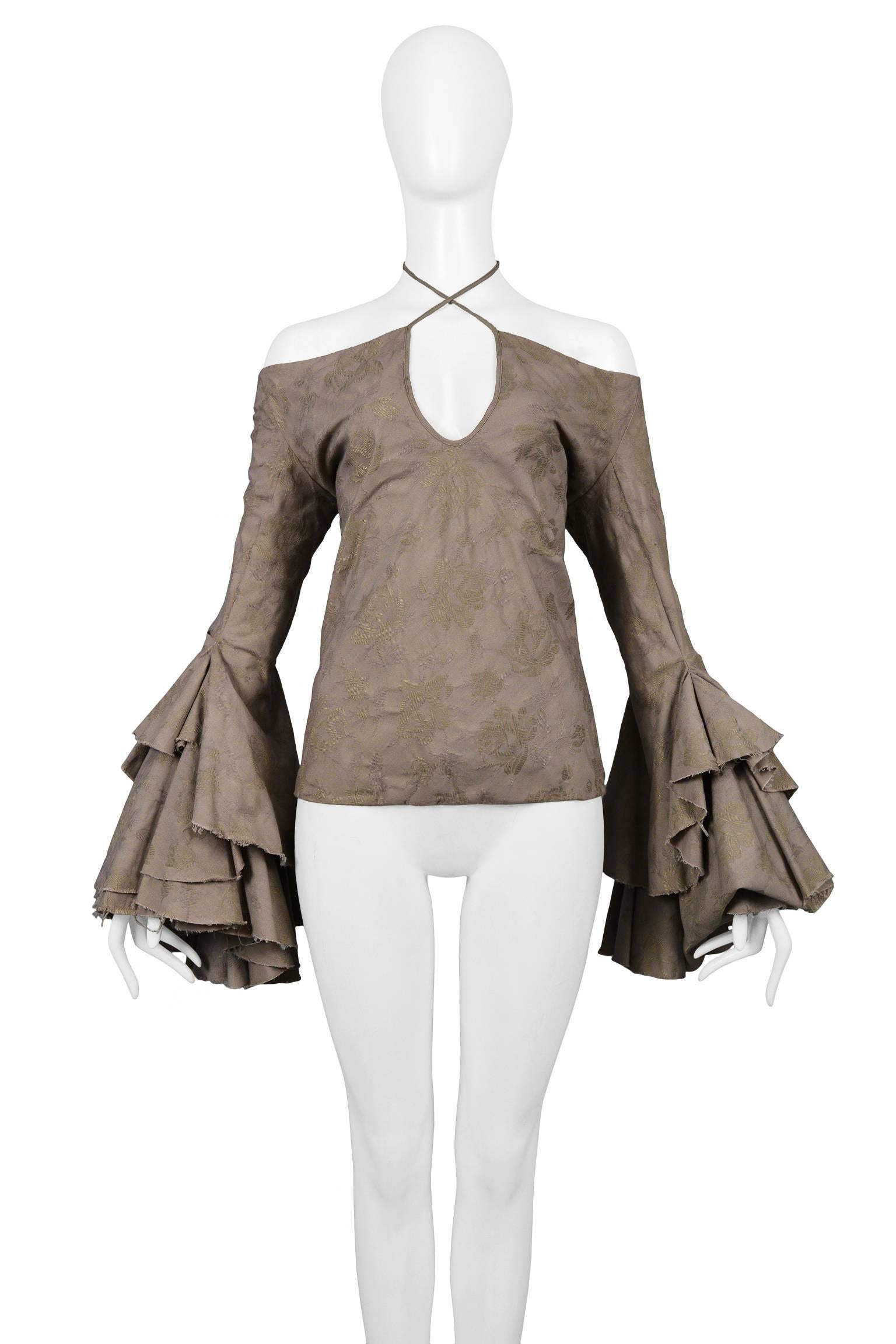Vintage Alexander McQueen grey off the shoulder top with tonal flower pattern throughout, keyhole neckline, heavily ruffled sleeves, and raw edges. From the Dance Of The Twisted Bull Spring / Summer 2002 Collection. Featured on the runway. 

Please
