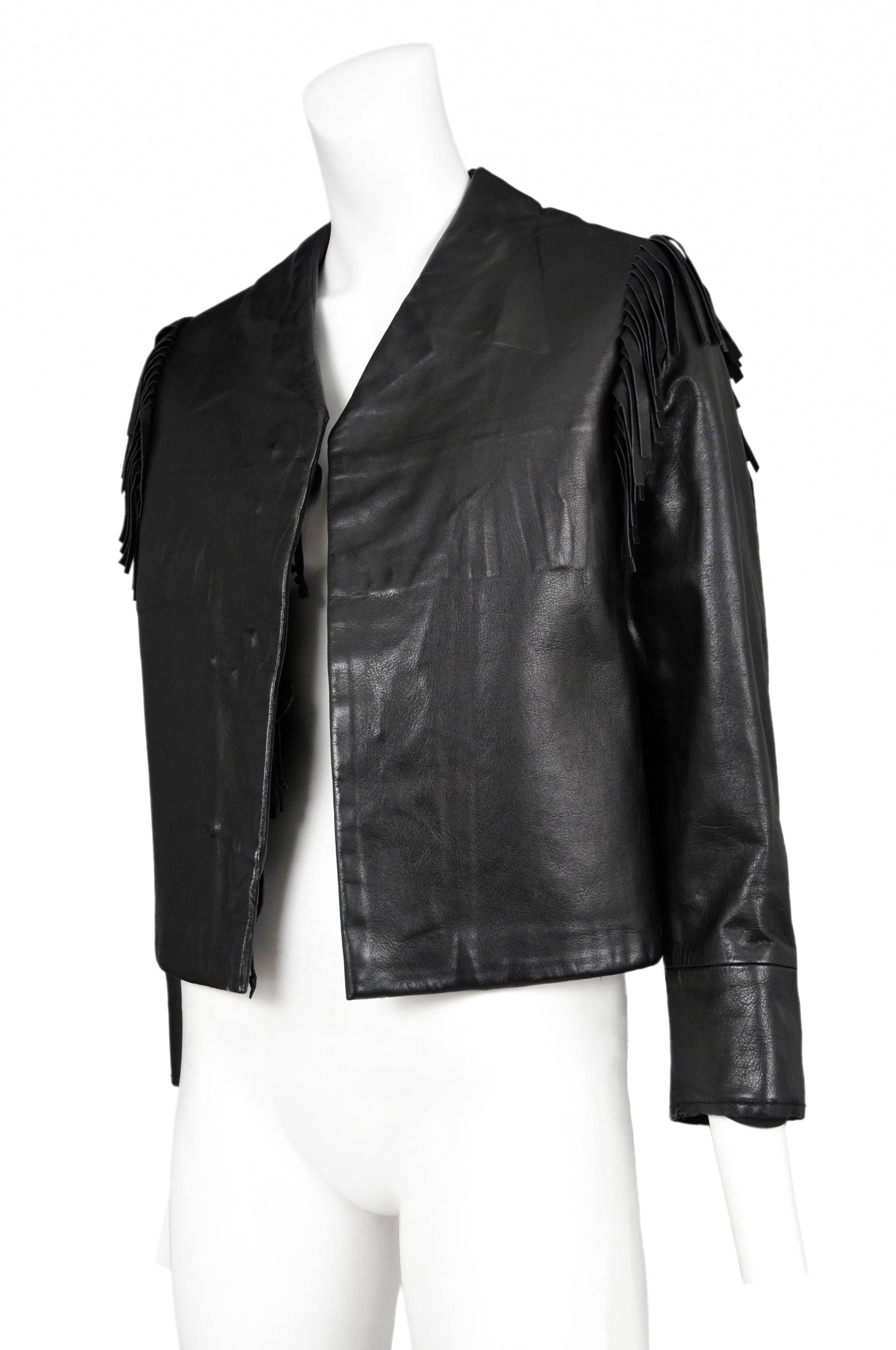 Vintage Maison Martin Margiela black leather jacket with details sewn inside of garment. Collar and buttons are sewn inside the face of the jacket. Fringe at back and on arms. Black lining. Circa 2000's.

Please inquire for additional images.