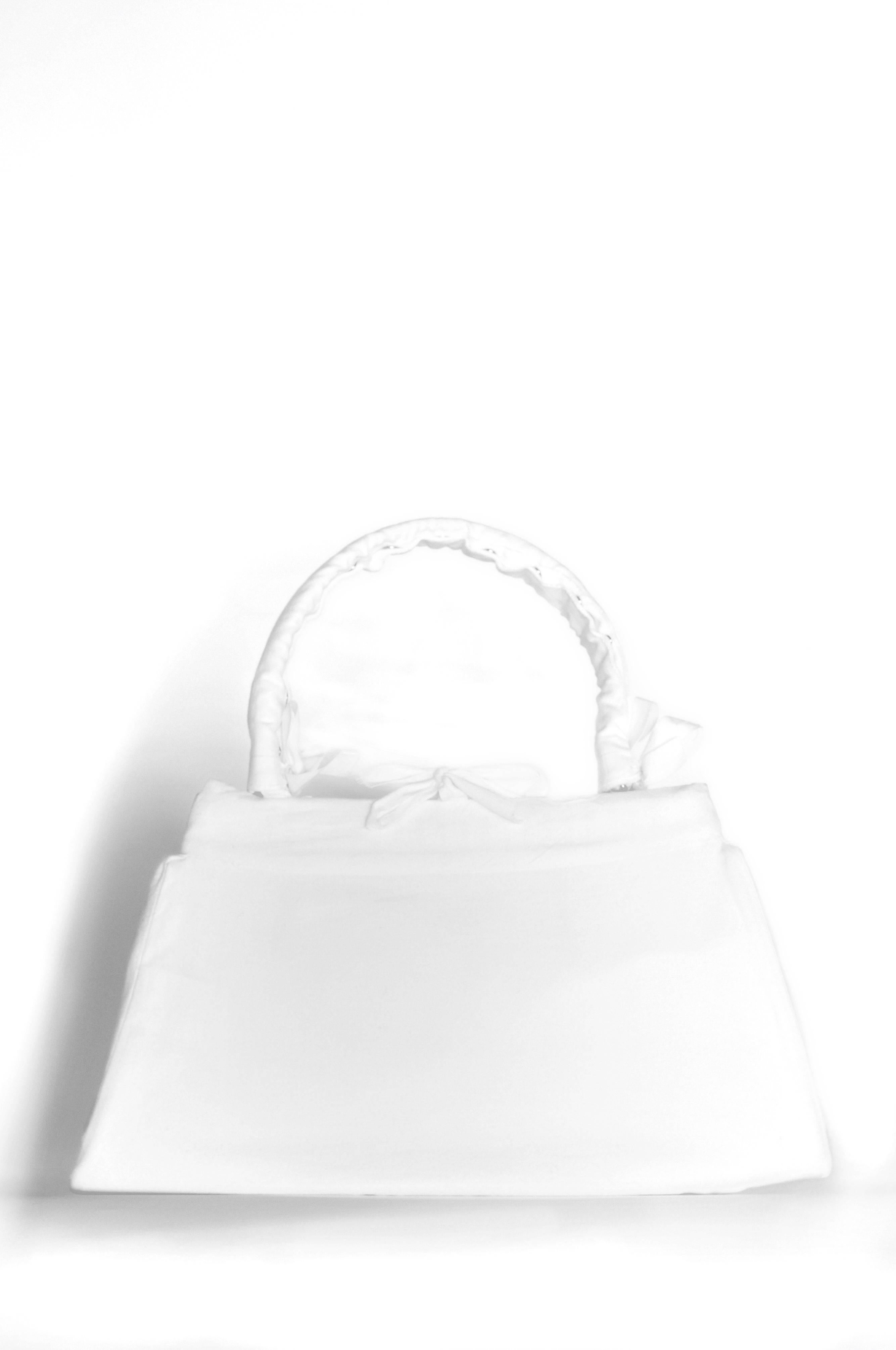 Vintage Maison Martin Margiela artisanal muslin handbag. Handbag is covered with a muslin cloth removable slip cover. Circa Autumn/Winter 2002/2003.
Please inquire for additional images.