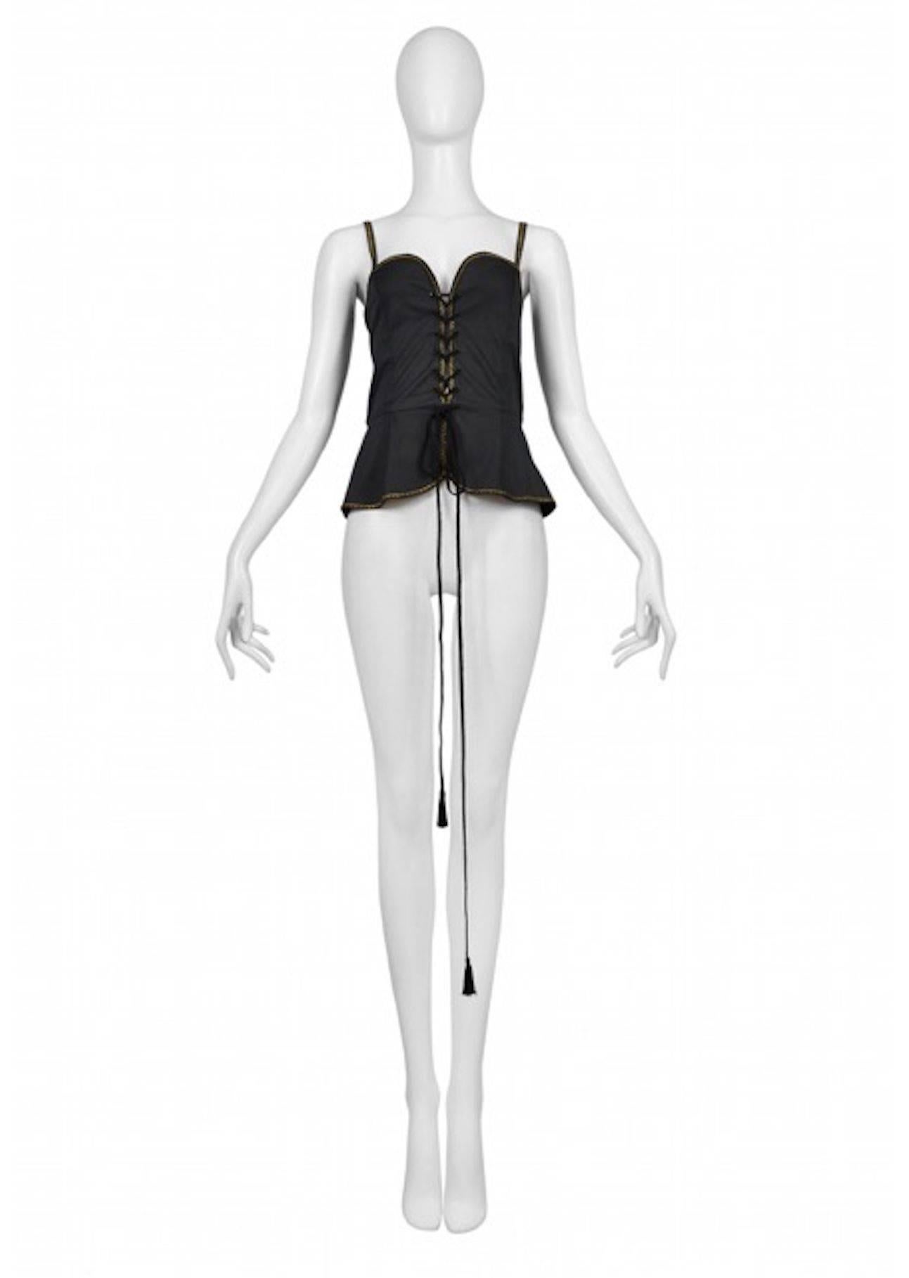 Vintage Yves Saint Laurent black safari corset tank featuring a built in peplum below the waist, gold rickrack trim along the edges and spaghetti straps, and tassel cording lacing up the front.
Please inquire for additional images.