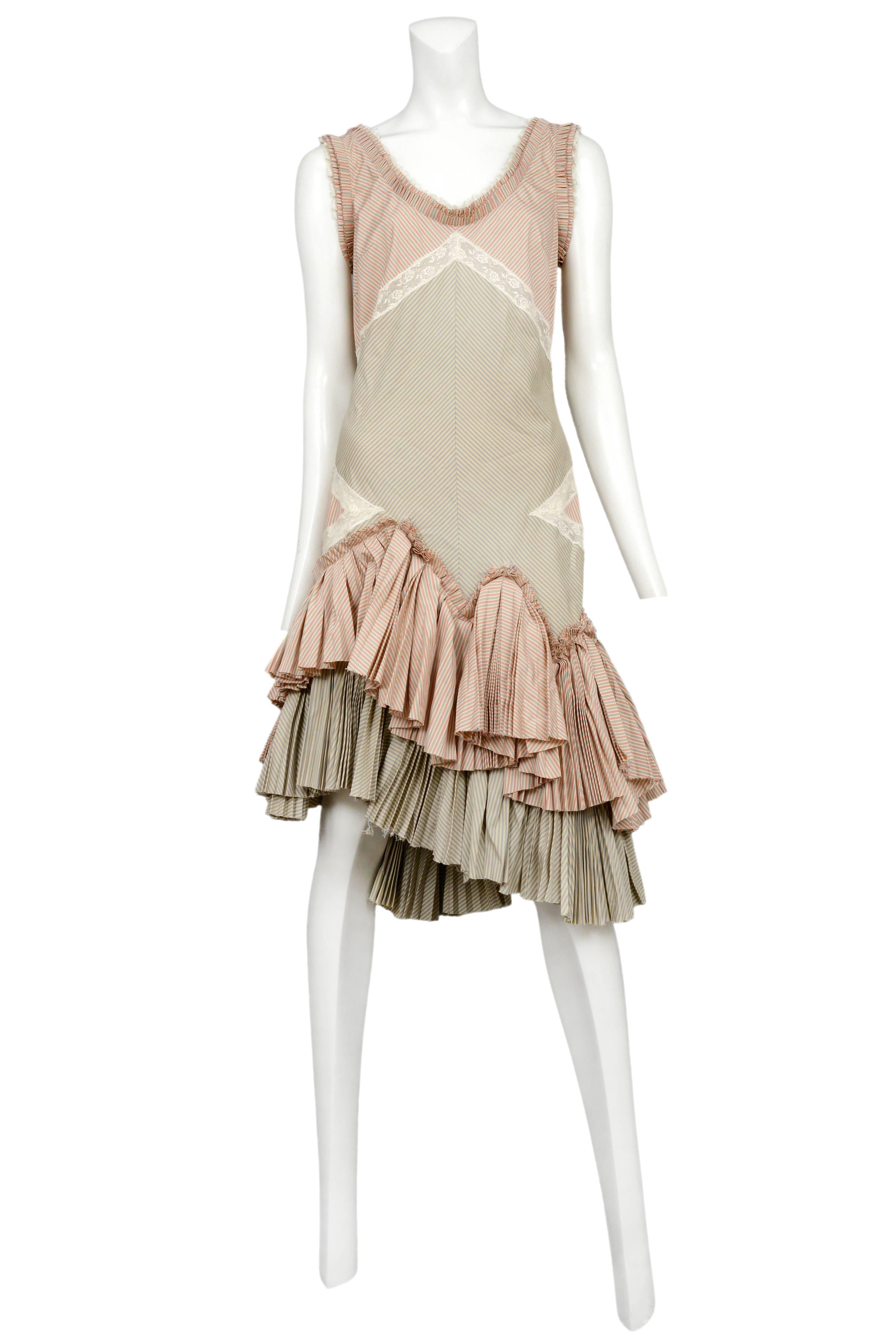 Vintage Alexander McQueen sleeveless pink stripe ruffle dress featuring two color ways of striped cotton interspersed with ivory lace trim and two tiers of pleated ruffles at the hem. Circa 2004.
Please inquire for additional images.