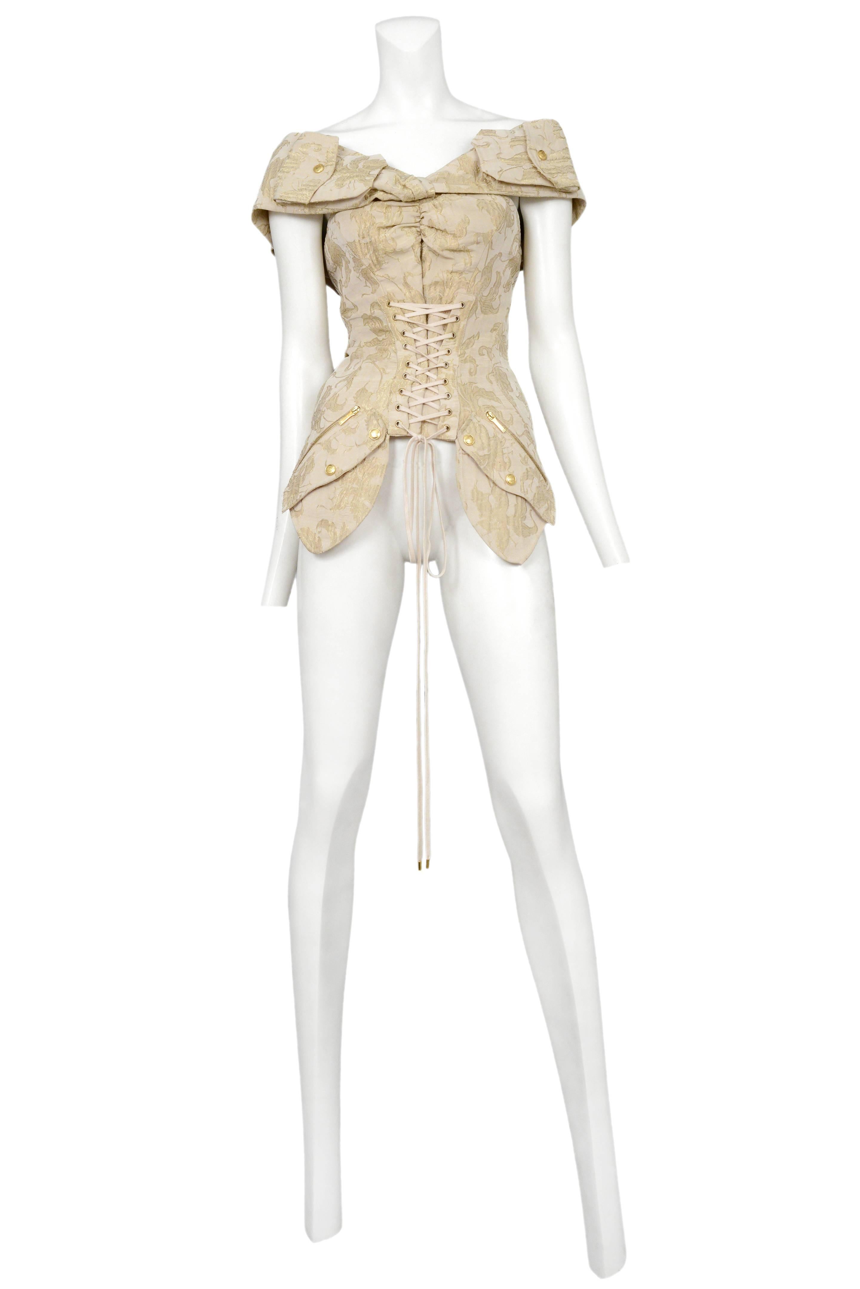 Vintage John Galliano for Dior gold brocade corset top featuring lace up detailing along the center front, gold snap and zipper pockets at the hips and wide shoulder straps, and a center back zipper.
Please inquire for additional images.