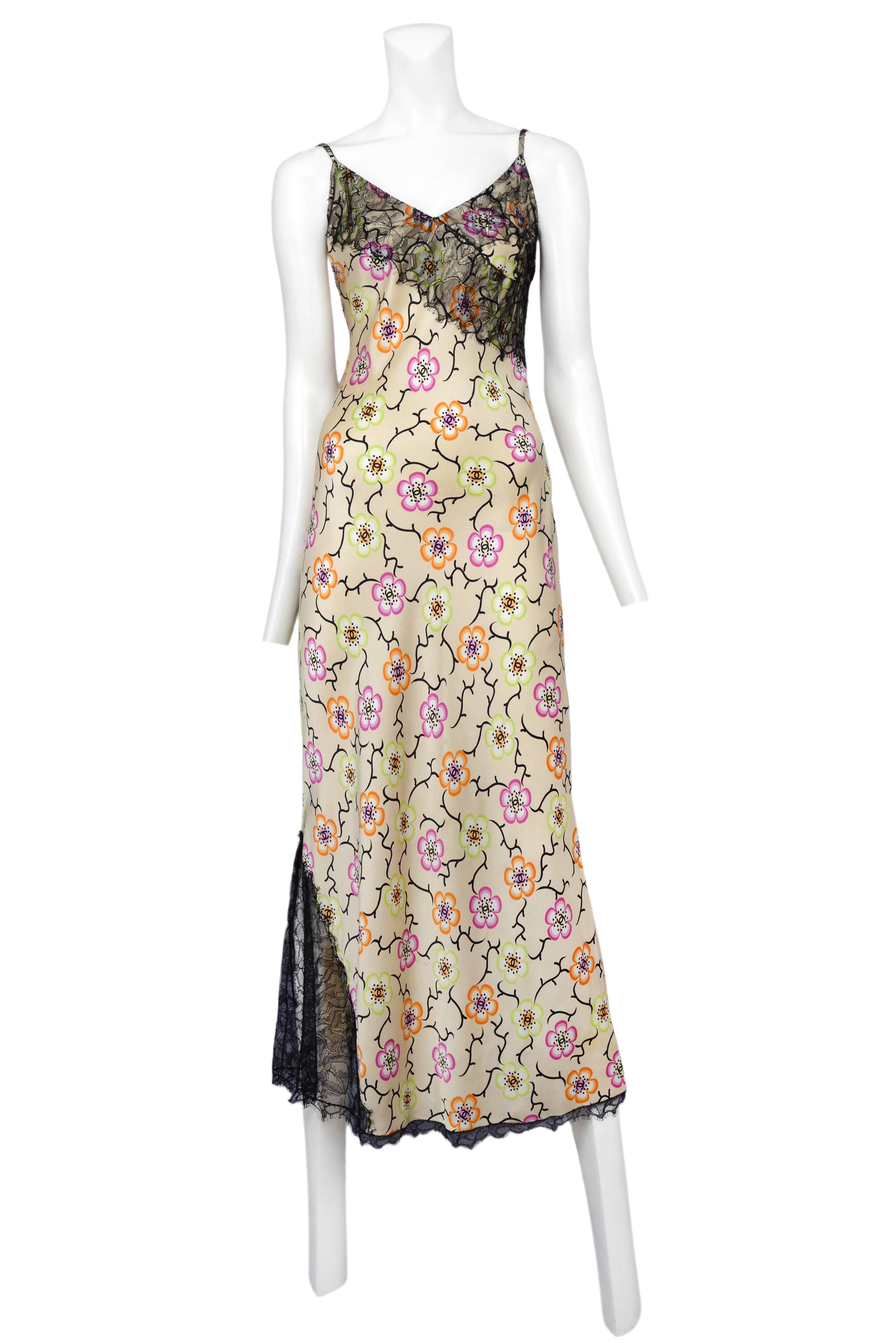 Vintage Chanel cream silk slip dress featuring black lace paneling near the hem of the right side as well as at the bust and an allover pink, orange and lime green floral print.
Please inquire for additional images.