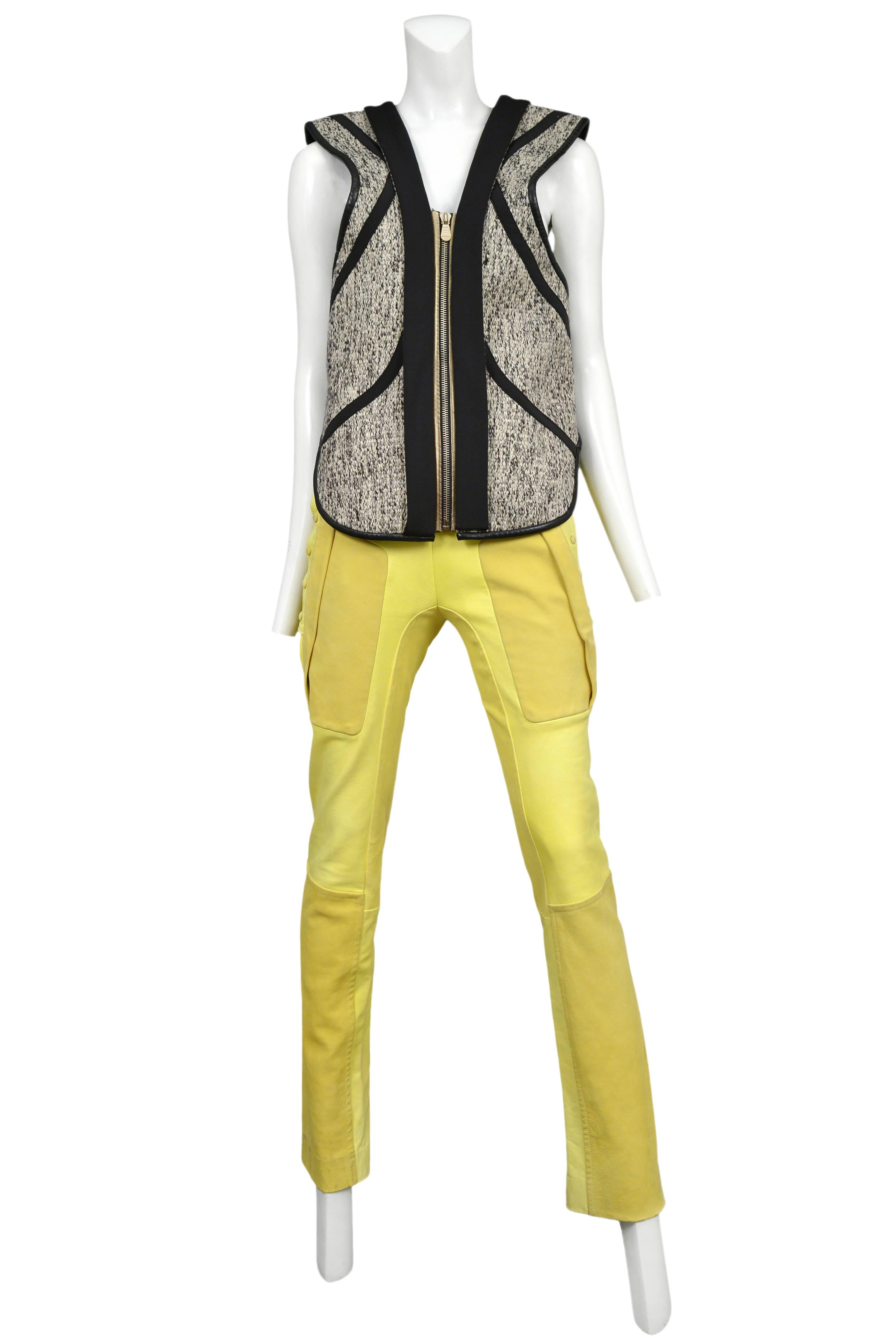 Vintage Nicolas Ghesquière for Balenciaga ensemble featuring an abstract wool zipper front vest and yellow leather moto pants with snap detailing up the sides. Runway ensemble from the Spring / Summer 2010 Collection.
Please inquire for additional