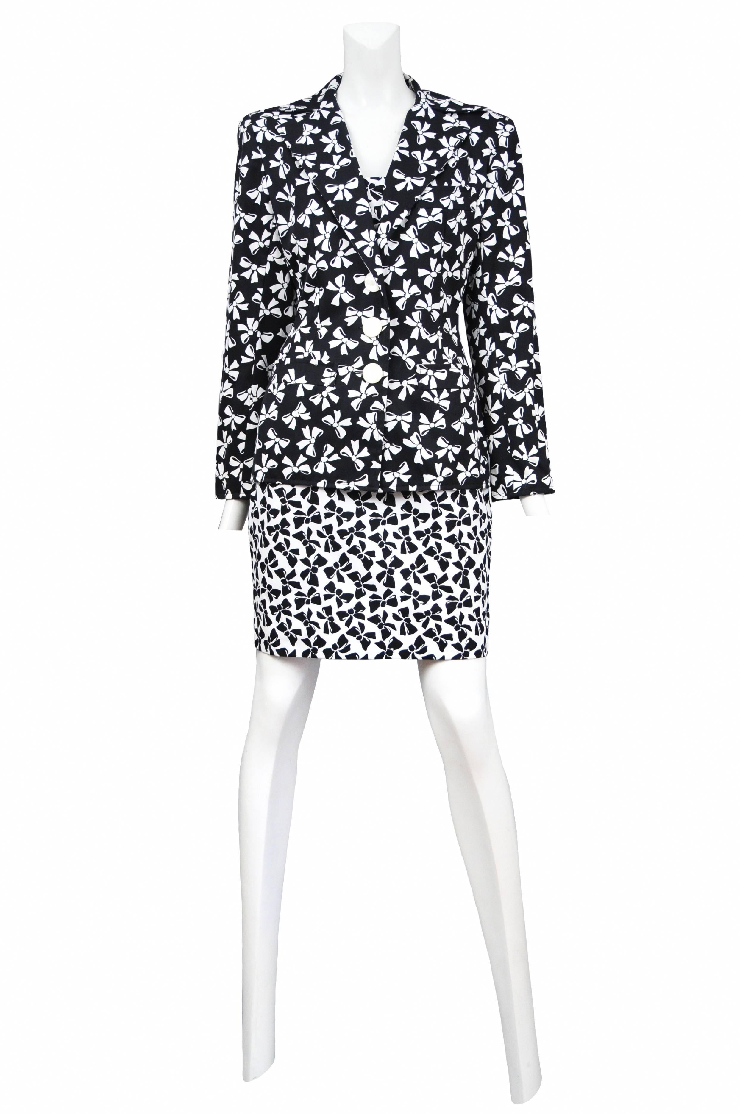 Vintage Yves Saint Laurent black and white ensemble featuring a traditional button front black blazer with a white bow print and matching strapless mini dress using the negative version of the bow print.
Please inquire for additional images.