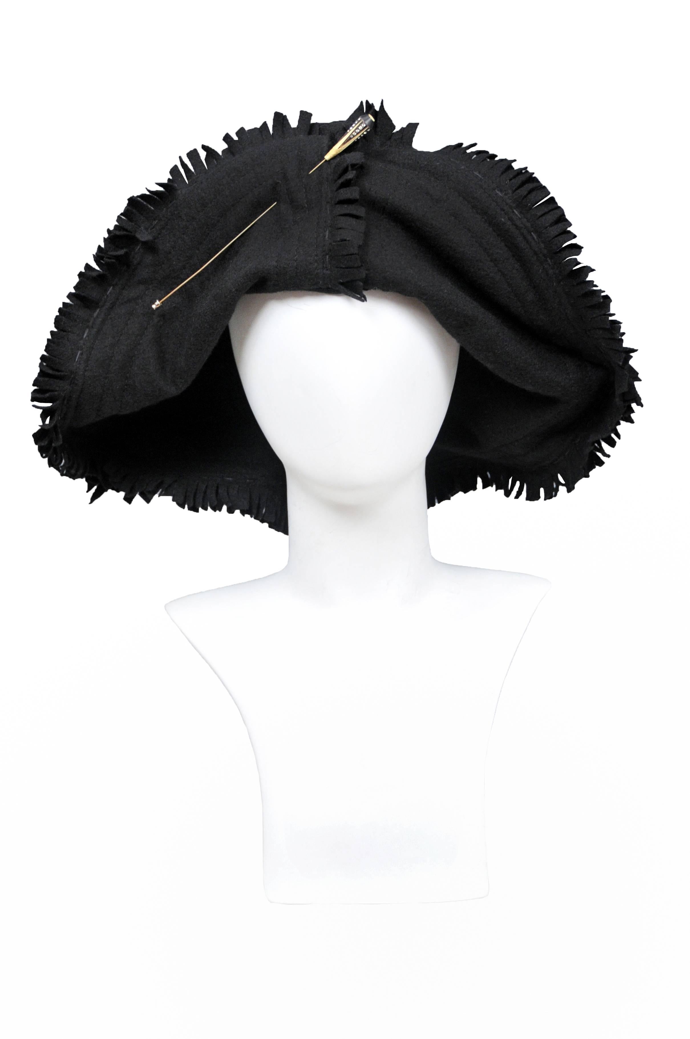 Vintage Junya Watanabe black wool hat featuring intentional frayed edges and adorned with a vintage hat pin at the center front.
Please inquire for additional images.
