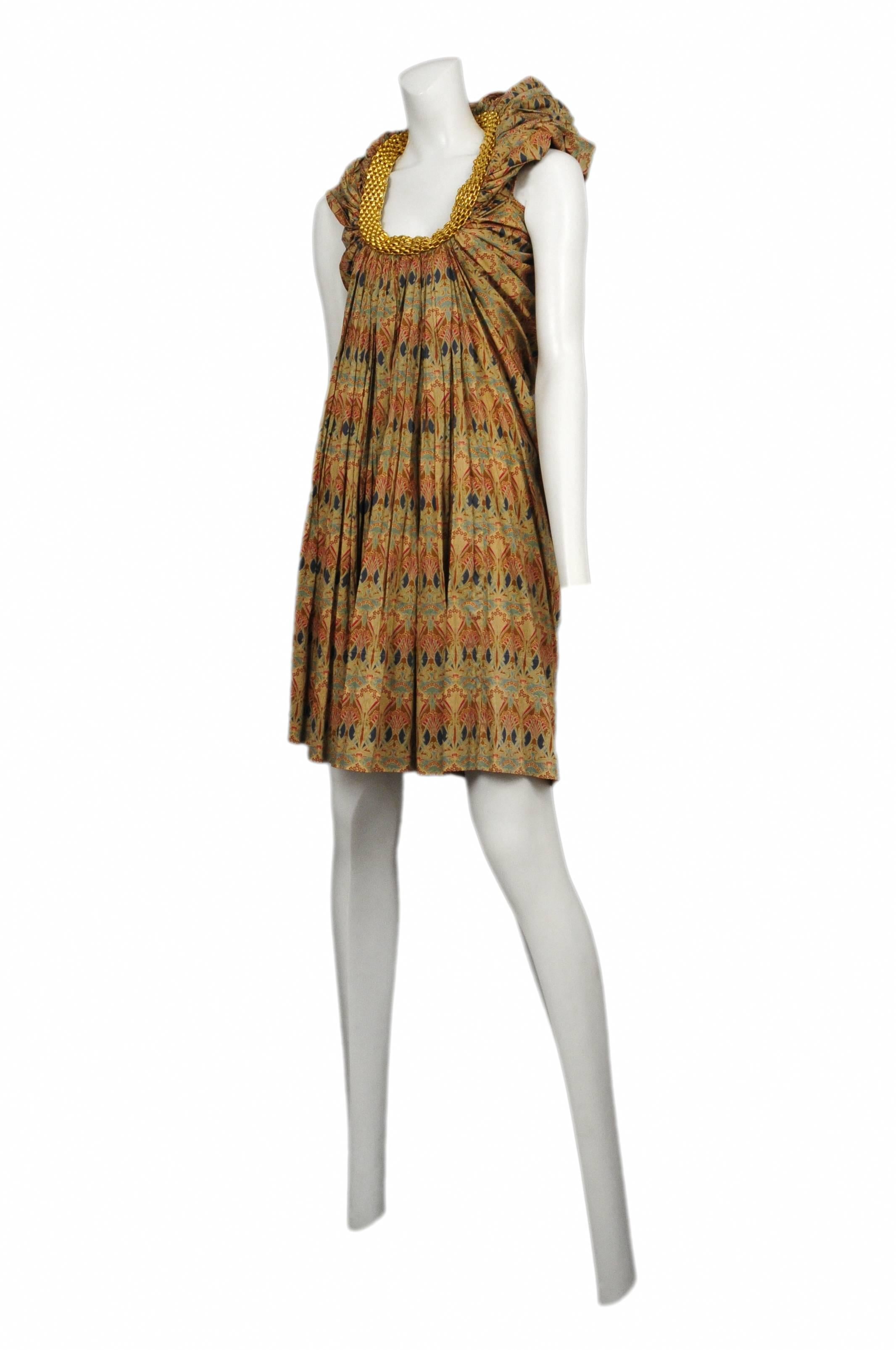 Vintage Junya Watanabe gold printed, sleeveless, knee length dress featuring a gold chain encircling the collar. Circa 2007.
Please inquire for additional images.