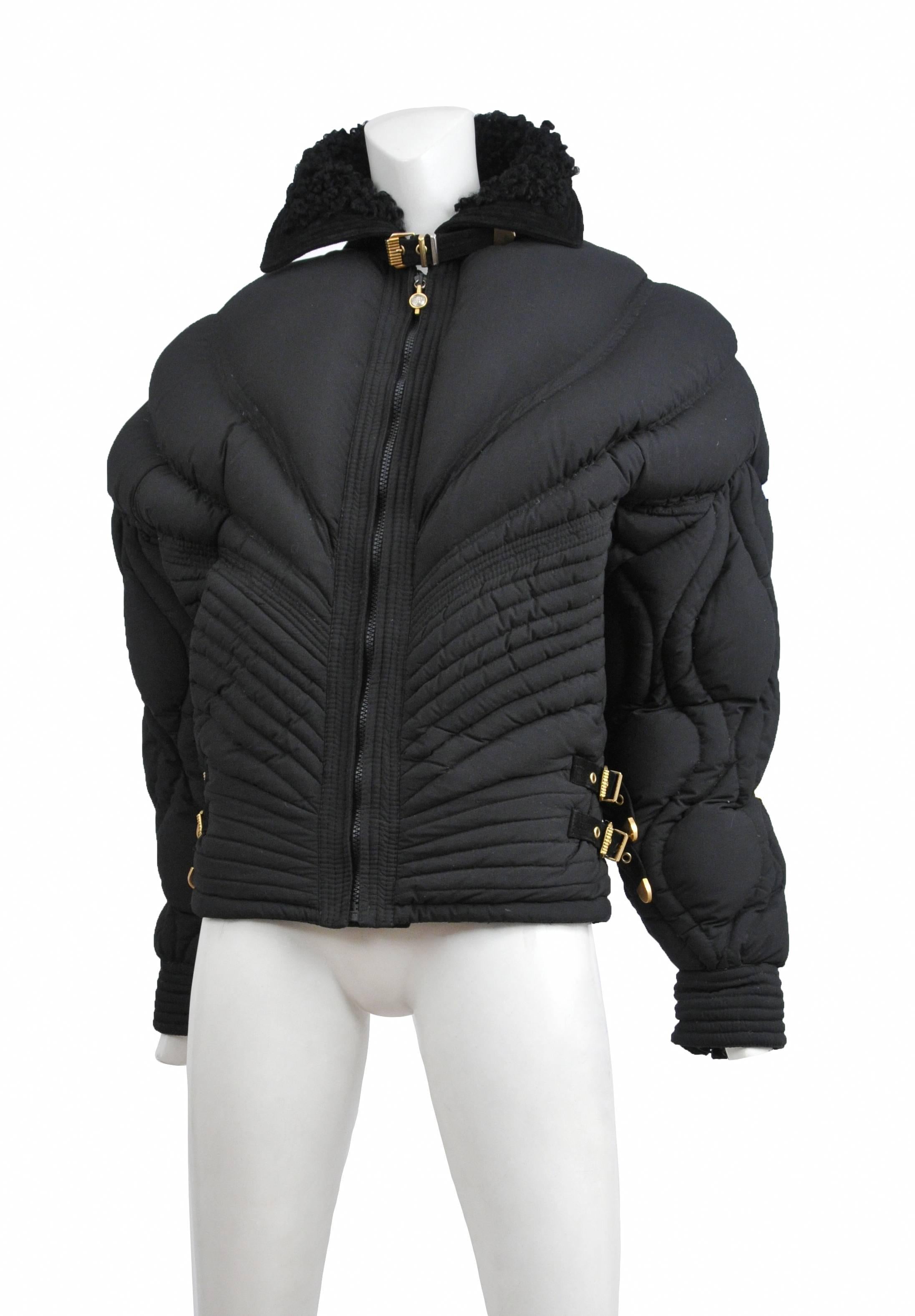 Vintage Gianni Versace rare apres quilted ski jacket in black brushed rayon. Corset style waist has leather and gold bondage buckles. The zipper pulls through out are adorned with the medusa icon. Jacket is trimmed in black suede with mongolian fur