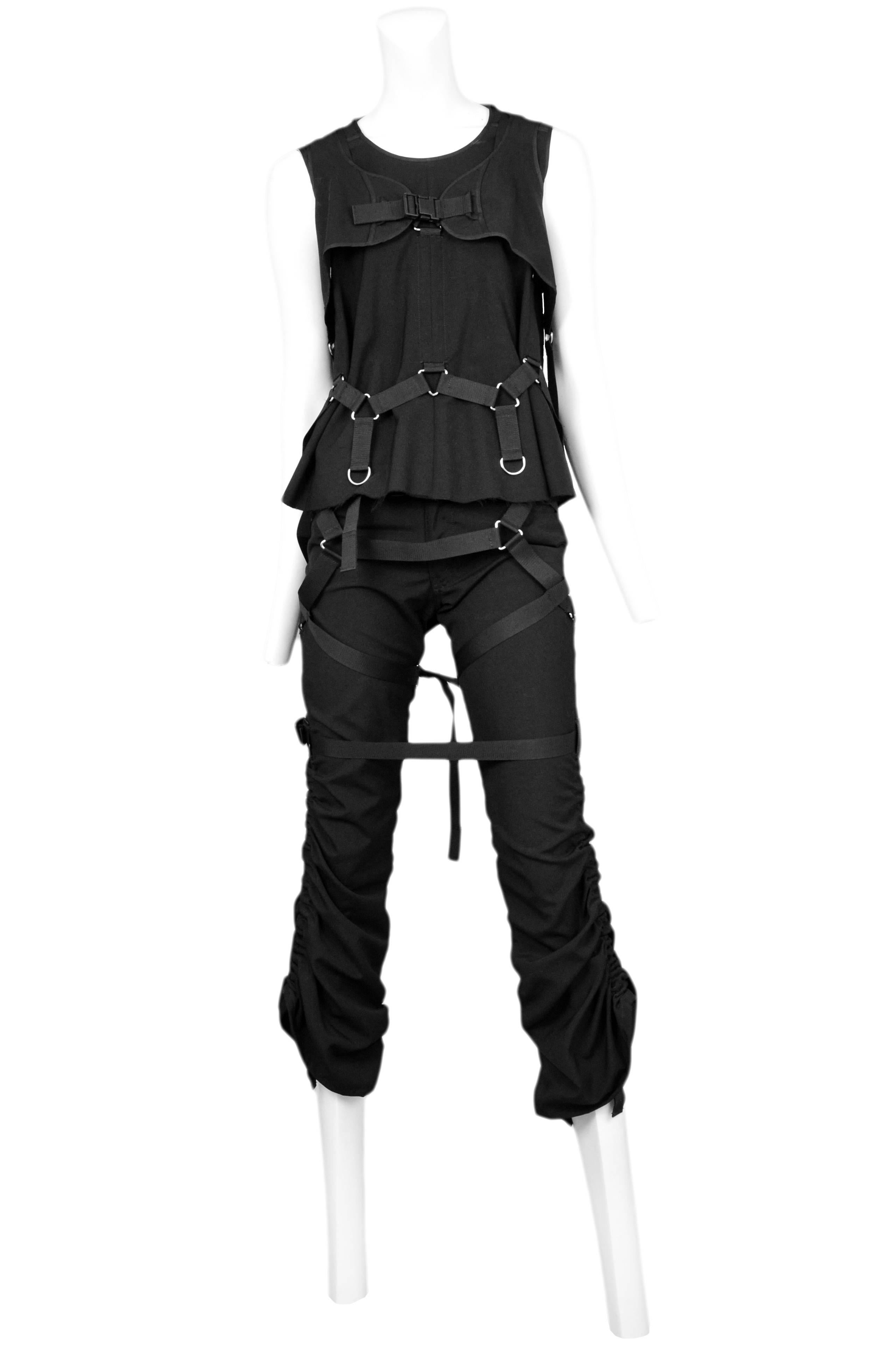 Vintage Junya Watanabe black parachute ensemble featuring a black sleeveless tank with black parachute straps and matching black pants that gather up the sides. Circa 2003.
Please inquire for additional images.